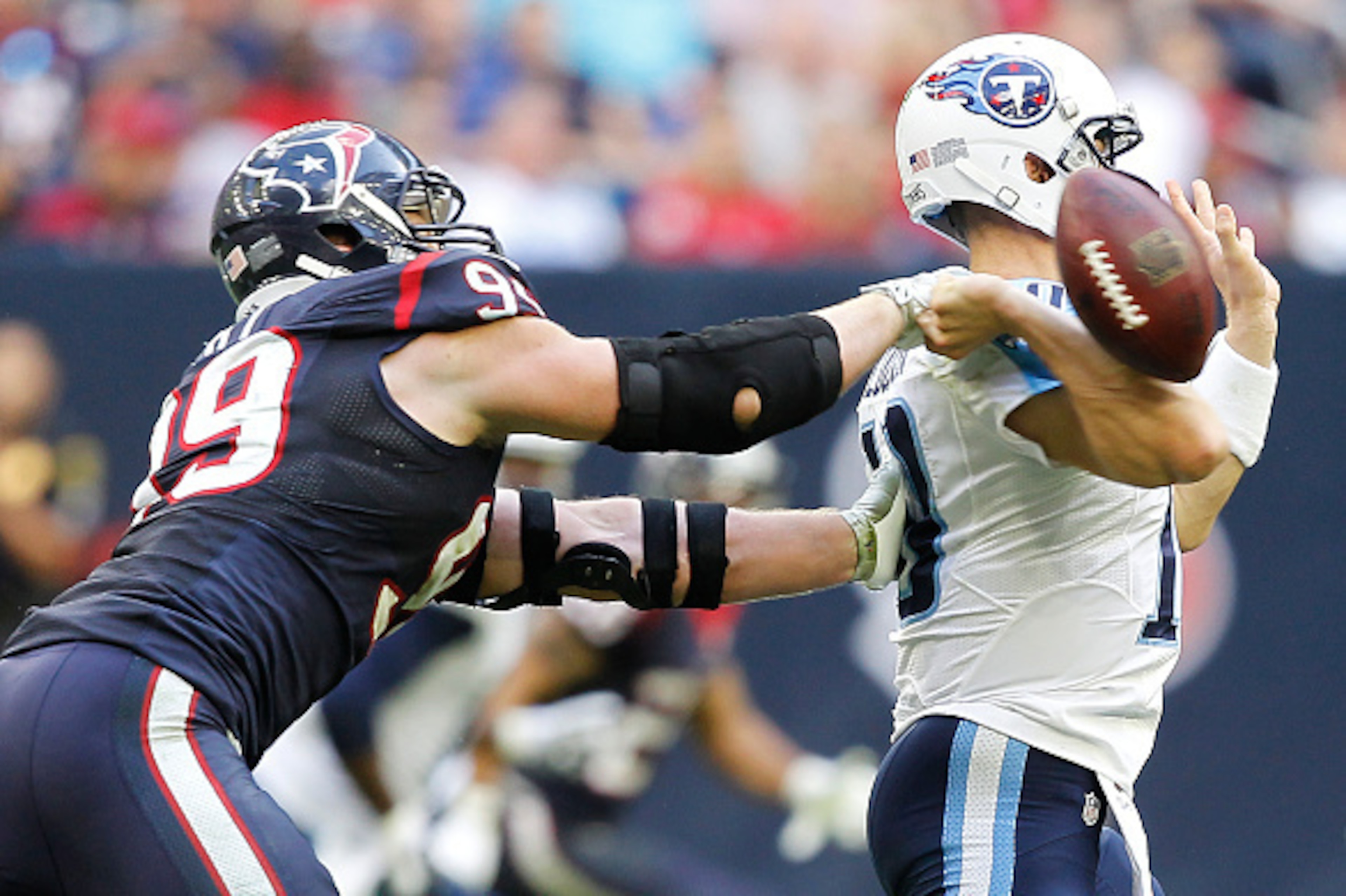 HOUSTON, TX - NOVEMBER 30: Jake Locker #10 of the Tennessee Titans fumbles the ball while being hit by J.J. Watt #99 of the Houston Texans in the fourth quarter in a NFL game on November 30, 2014 at NRG Stadium in Houston, Texas. (Photo by Bob Levey/Getty HOUSTON, TX - NOVEMBER 30: Jake Locker #10 of the Tennessee Titans fumbles the ball while being hit by J.J. Watt #99 of the Houston Texans in the fourth quarter in a NFL game on November 30, 2014 at NRG Stadium in Houston, Texas. (Photo by Bob Levey/Getty