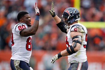 CLEVELAND, OH - NOVEMBER 16:  J.J. Watt #99 celebrates his touchdown with Andre Johnson #80 of the Houston Texans during the first quarter against the Cleveland Browns at FirstEnergy Stadium on November 16, 2014 in Cleveland, Ohio.  (Photo by Gregory Sham