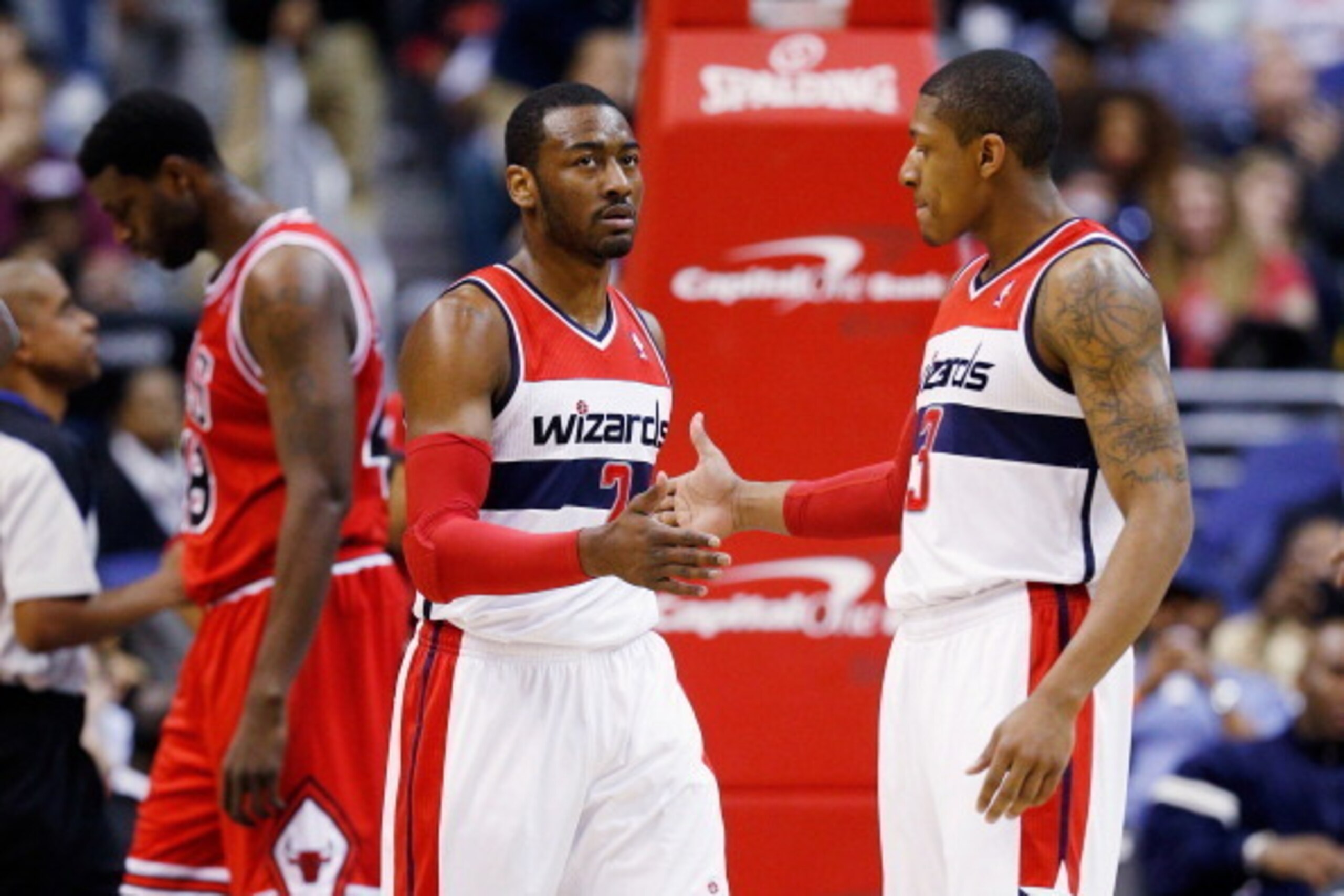 WASHINGTON, DC - APRIL 02: John Wall #2 and Bradley Beal #3 of the Washington Wizards celebrate after Wall scored against the Chicago Bulls at Verizon Center on April 2, 2013 in Washington, DC. NOTE TO USER: User expressly acknowledges and agrees that, by