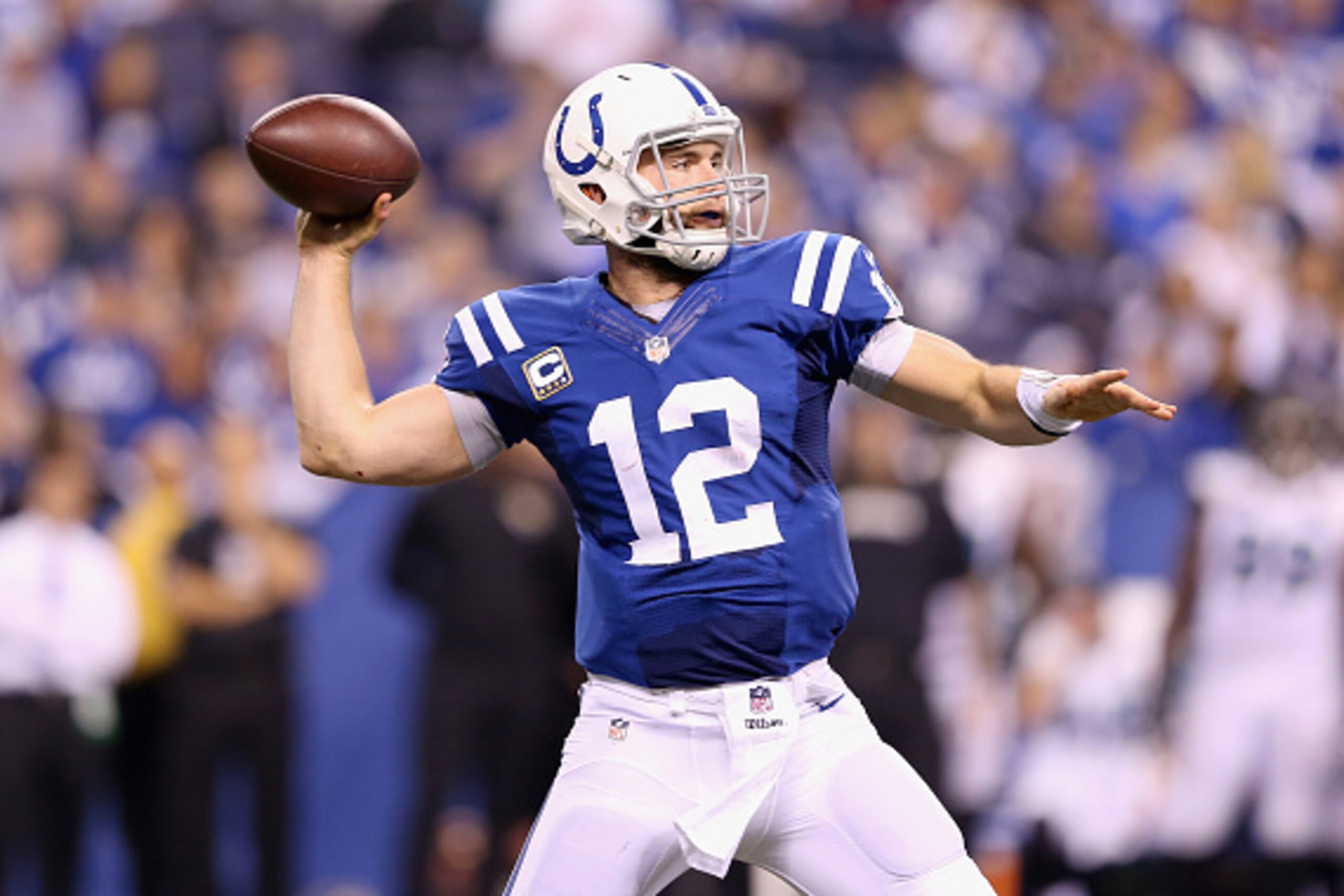 INDIANAPOLIS, IN - NOVEMBER 23:  Andrew Luck #12 of the Indianapolis Colts throws a touchdown pass during the game against the Jacksonville Jaguars at Lucas Oil Stadium on November 23, 2014 in Indianapolis, Indiana.  (Photo by Andy Lyons/Getty Images)