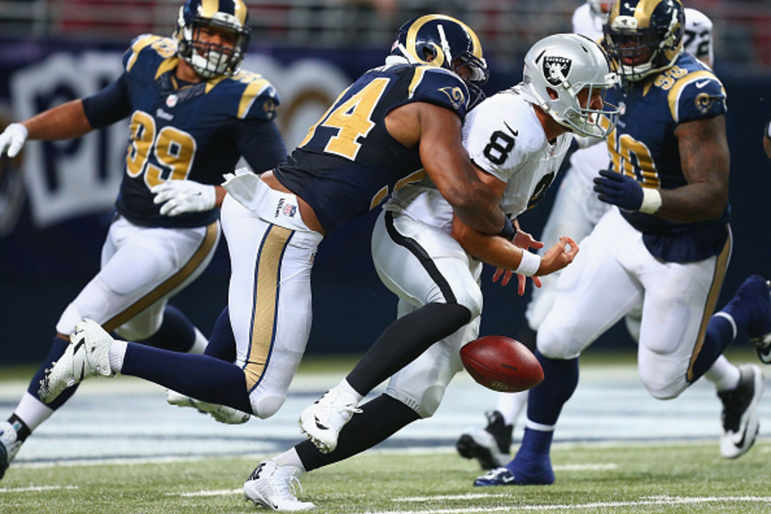 ST. LOUIS, MO - NOVEMBER 30: Matt Schaub #8 of the Oakland Raiders fumbles the ball after being sacked against the St. Louis Rams in the fourth quarter at the Edward Jones Dome on November 30, 2014 in St. Louis, Missouri.  The Rams beat the Raiders 52-0. 