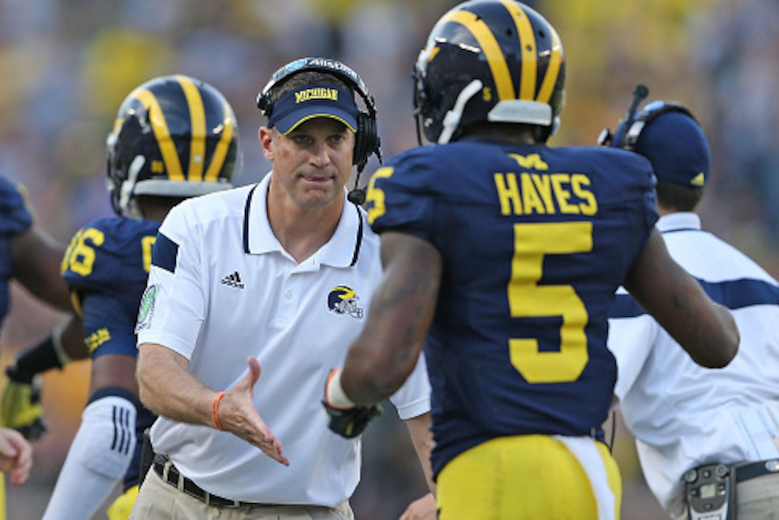 ANN ARBOR, MI - SEPTEMBER 27: Michigan Wolverines offensive coordinator Doug Nussmeier congratulates running back Justice Hayes #5 during the second quarter of the game against the Minnesota Golden Gophers at Michigan Stadium on September 27, 2014 in Ann 
