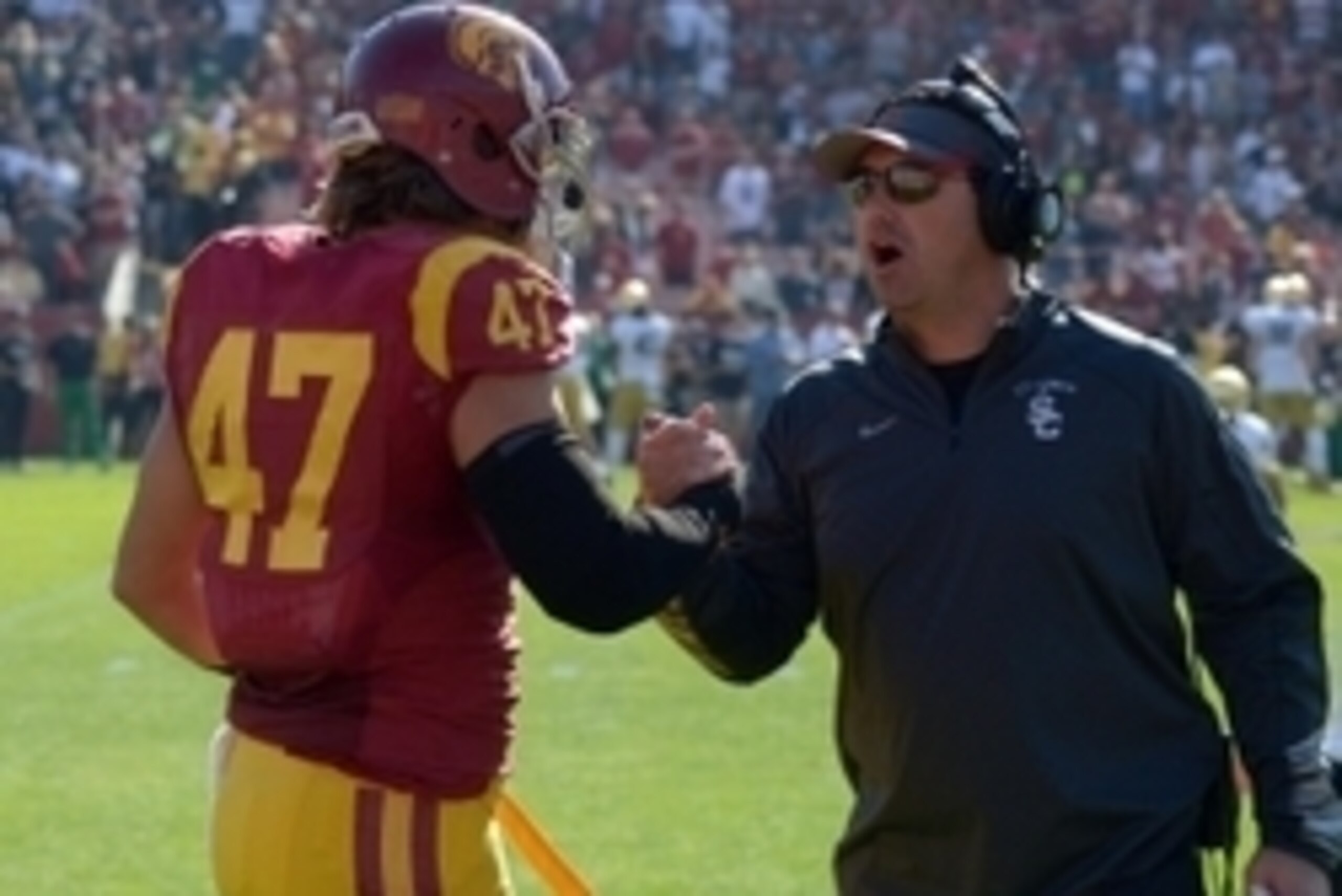 Nov 29, 2014; Los Angeles, CA, USA; Southern California Trojans coach Steve Sarkisian (right) shakes hands with linebacker Scott Felix (47) against the Notre Dame Fighting Irish at Los Angeles Memorial Coliseum. Mandatory Credit: Kirby Lee-USA TODAY Sport