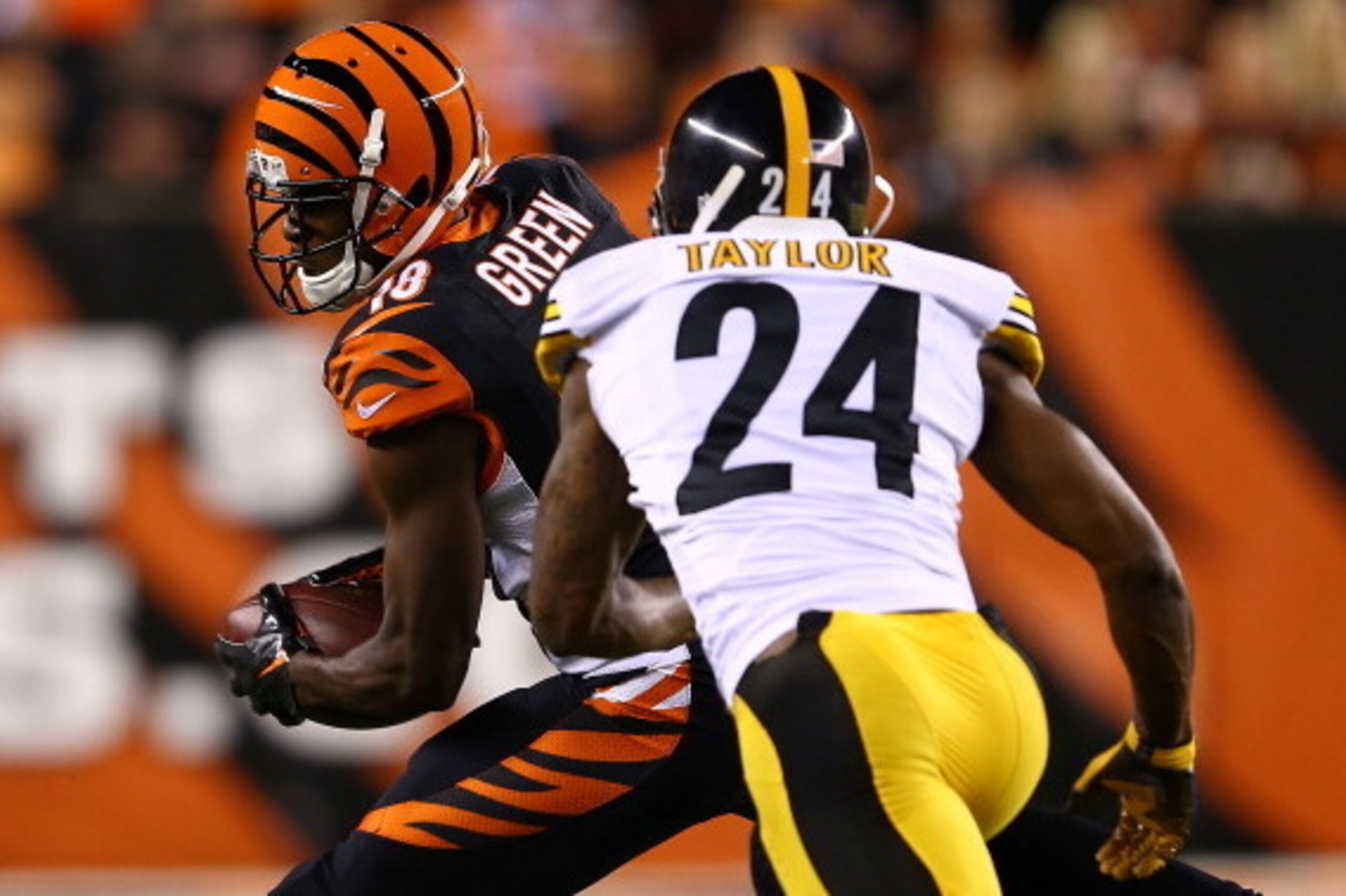 CINCINNATI, OH - SEPTEMBER 16:  Wide receiver A.J. Green #18 of the Cincinnati Bengals with the ball after a catch against cornerback Ike Taylor #24 of the Pittsburgh Steelers in the second quarter at Paul Brown Stadium on September 16, 2013 in Cincinnati
