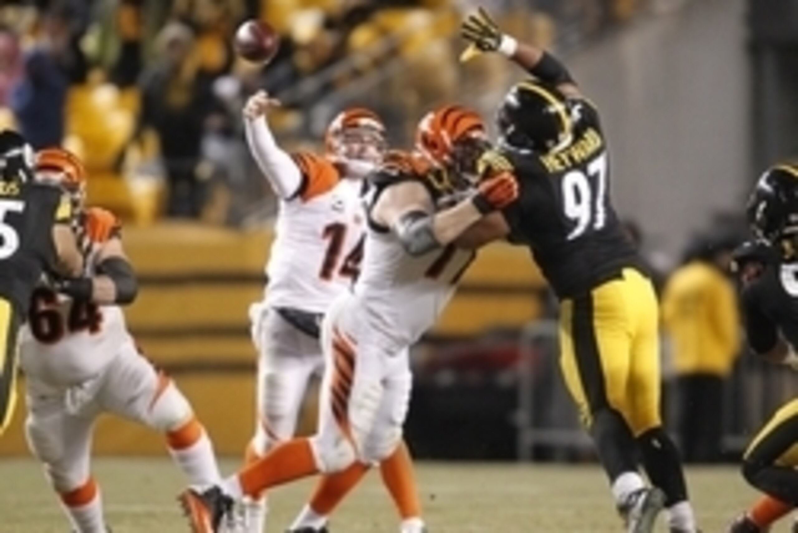 Dec 15, 2013; Pittsburgh, PA, USA; Cincinnati Bengals quarterback Andy Dalton (14) passes the ball over Pittsburgh Steelers defensive end Cameron Heyward (97) during the third quarter at Heinz Field. The Steelers won 30-20. Mandatory Credit: Charles LeCla