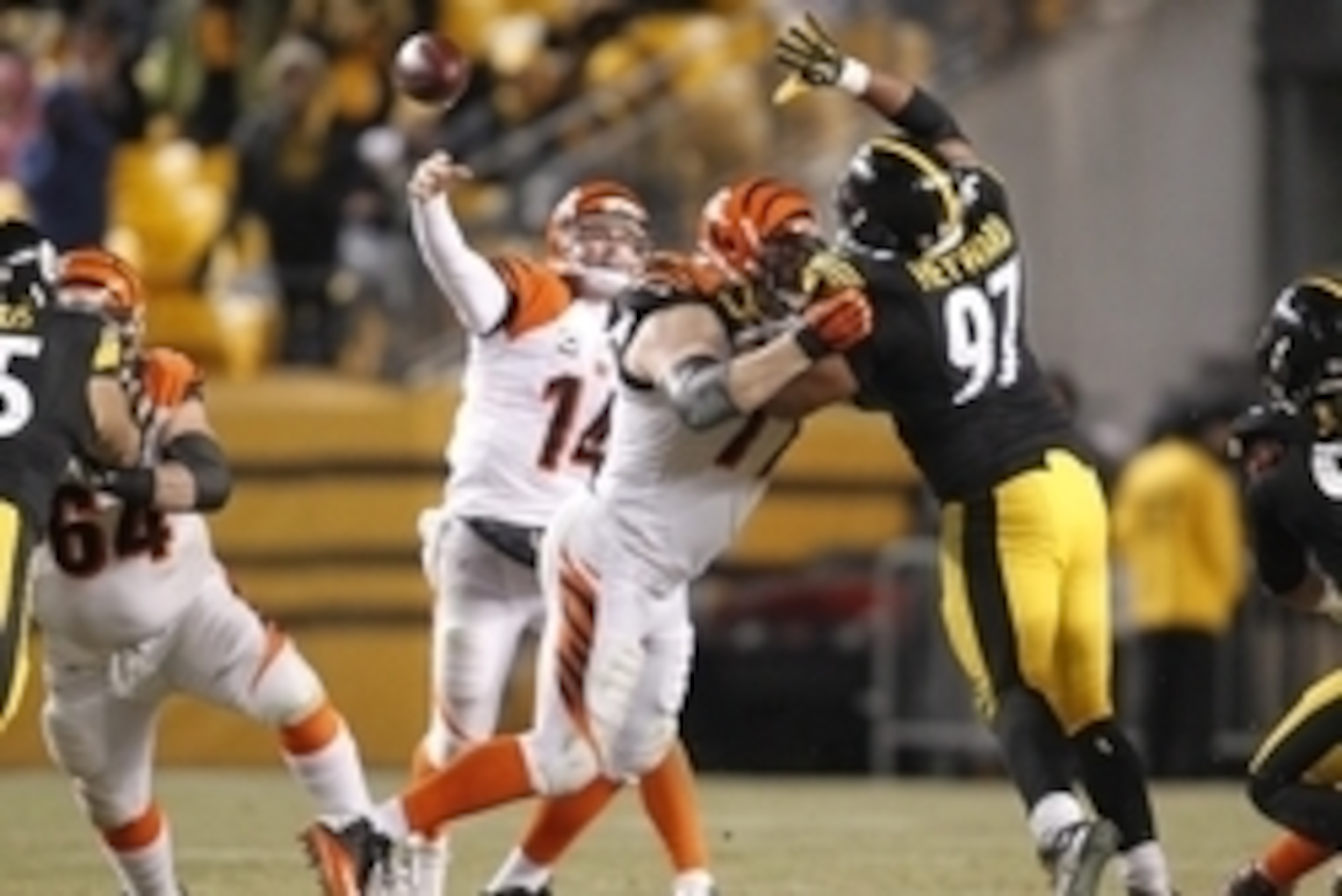 Dec 15, 2013; Pittsburgh, PA, USA; Cincinnati Bengals quarterback Andy Dalton (14) passes the ball over Pittsburgh Steelers defensive end Cameron Heyward (97) during the third quarter at Heinz Field. The Steelers won 30-20. Mandatory Credit: Charles LeCla