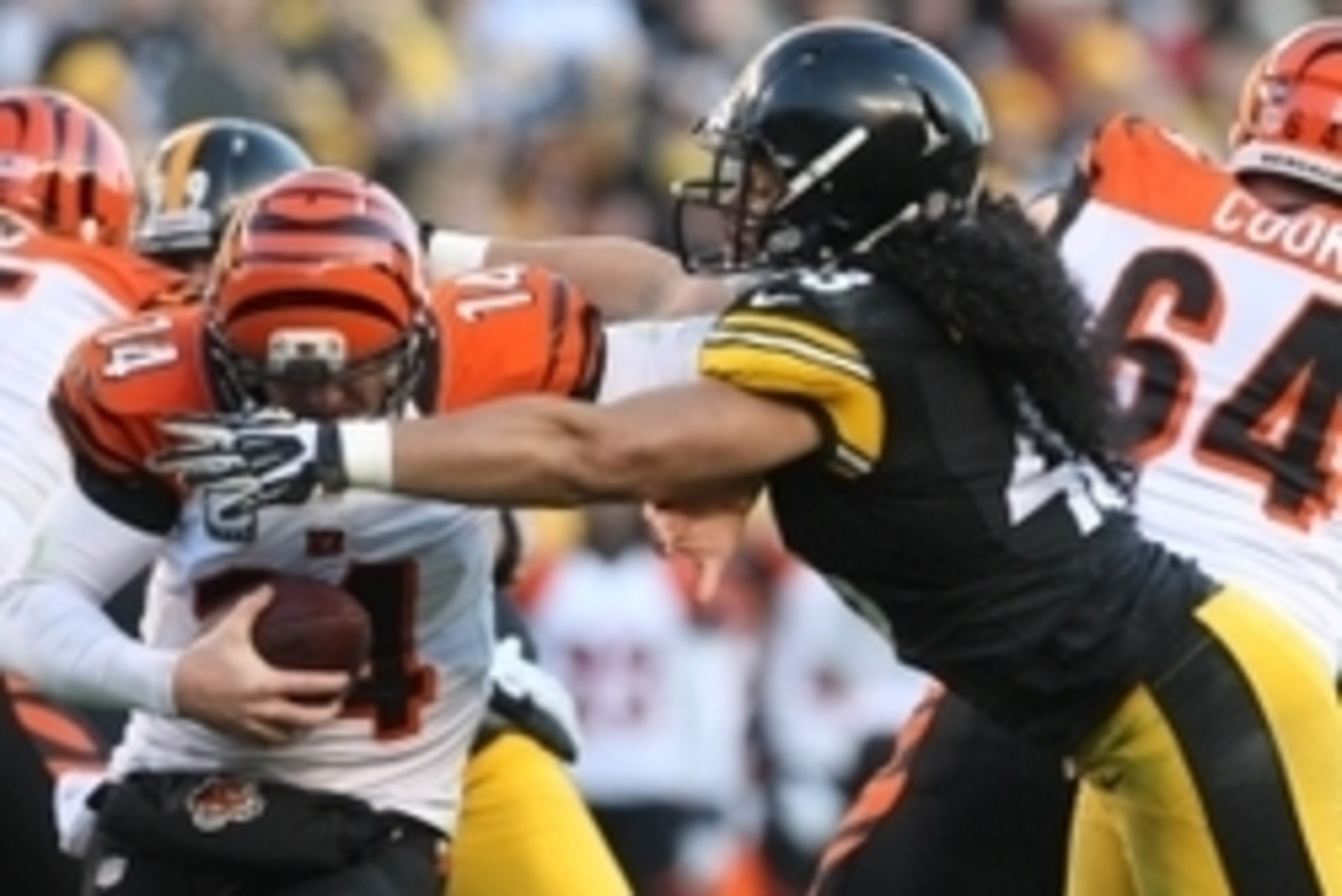 Dec 23, 2012; Pittsburgh, PA, USA; Pittsburgh Steelers safety Troy Polamalu (43) sacks Cincinnati Bengals quarterback Andy Dalton (14) during the second half of the game at Heinz Field. The Bengals won the game, 13-10. Mandatory Credit: Jason Bridge-USA T