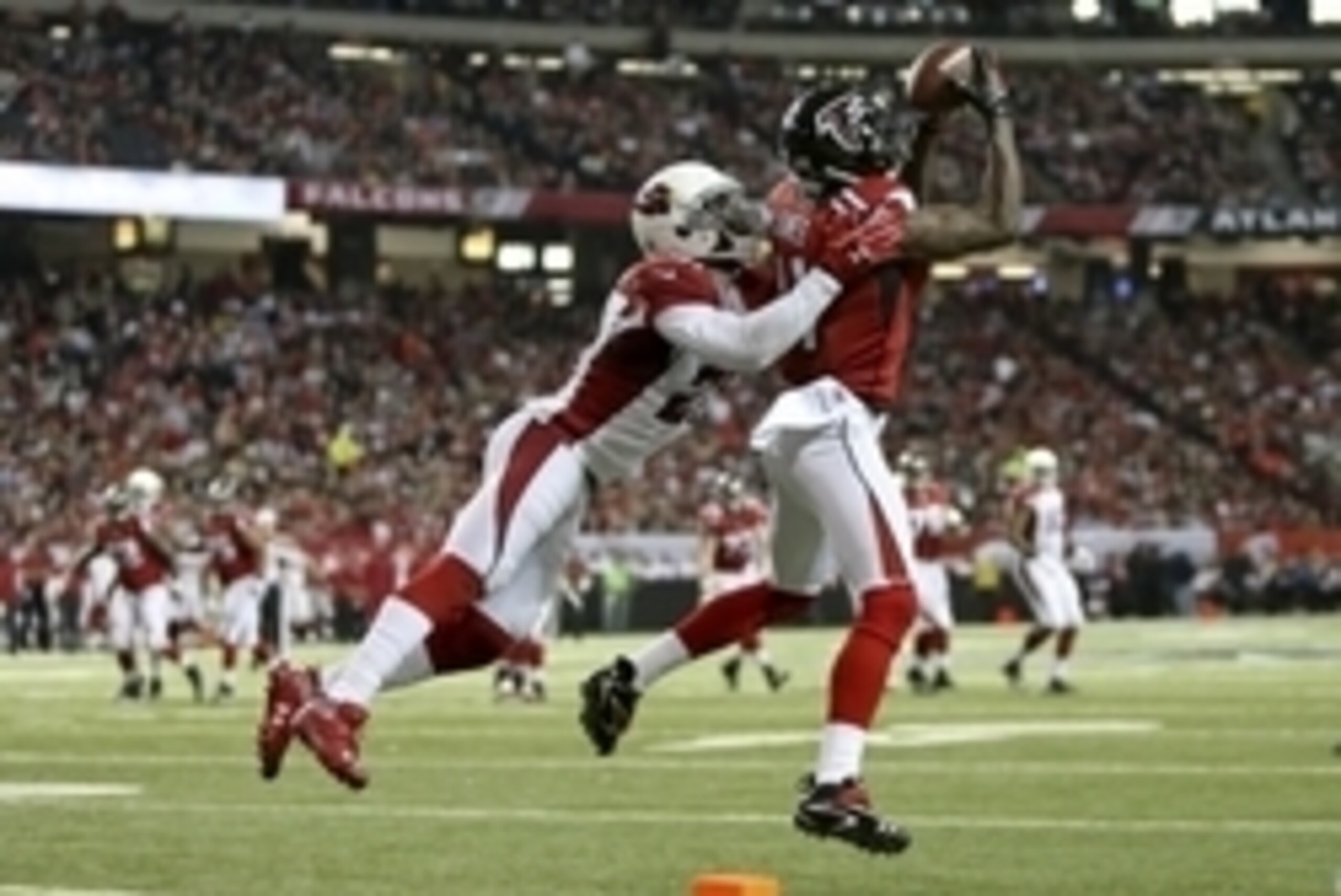 Nov 30, 2014; Atlanta, GA, USA; Atlanta Falcons wide receiver Julio Jones (11) makes a catch against Arizona Cardinals cornerback Patrick Peterson (21) in the second quarter of their game at the Georgia Dome. Mandatory Credit: Jason Getz-USA TODAY Sports