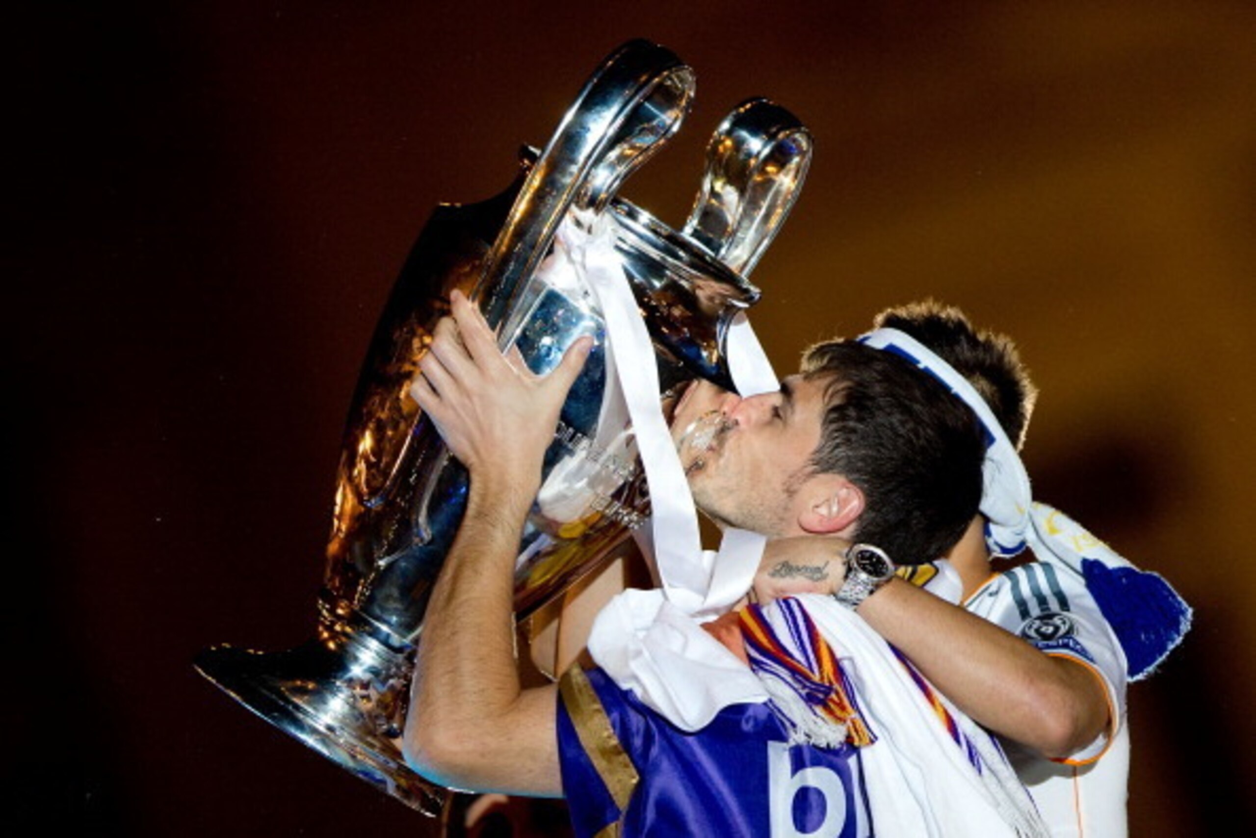 MADRID, SPAIN - MAY 25: Captain goalkeeper Iker Casillas (L) of Real Madrid CF kisses the UEFA Champions League cup as his teammate Jese Rodriguez (R) embraces him celebratin with his teammate Sergio Ramos their victory on the UEFA Champions League Final MADRID, SPAIN - MAY 25: Captain goalkeeper Iker Casillas (L) of Real Madrid CF kisses the UEFA Champions League cup as his teammate Jese Rodriguez (R) embraces him celebratin with his teammate Sergio Ramos their victory on the UEFA Champions League Final