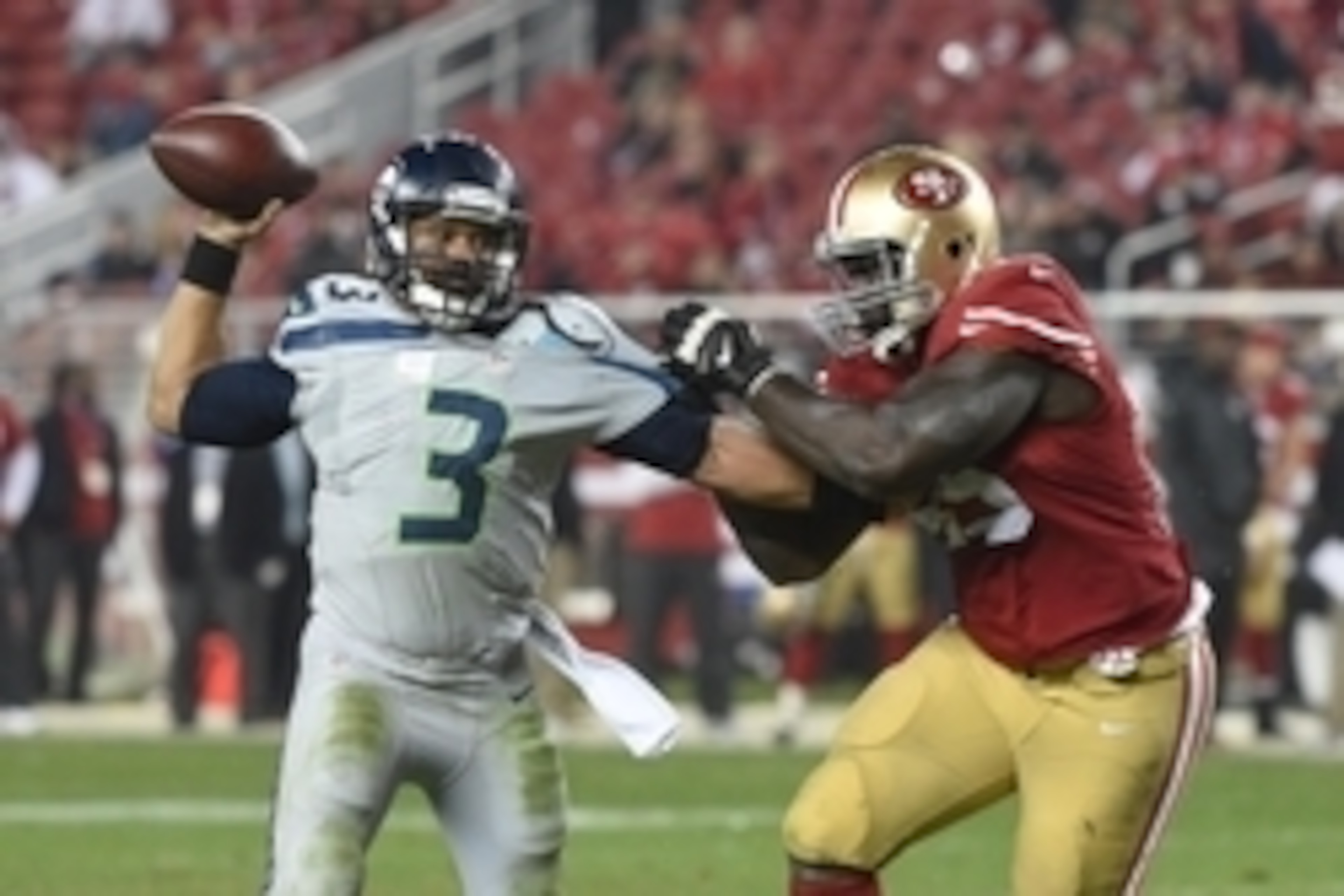 November 27, 2014; Santa Clara, CA, USA; Seattle Seahawks quarterback Russell Wilson (3) passes the football against San Francisco 49ers defensive end Tank Carradine (95) during the fourth quarter at Levi's Stadium. The Seahawks defeated the 49ers 19-3. M