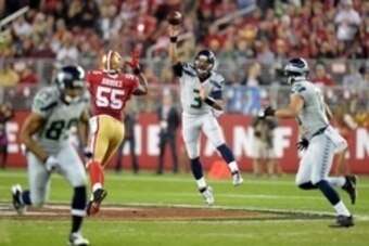 Nov 27, 2014; Santa Clara, CA, USA; Seattle Seahawks quarterback Russell Wilson (3) throws a pass against the San Francisco 49ers in the Thanksgiving game at Levi's Stadium. Mandatory Credit: Kirby Lee-USA TODAY Sports