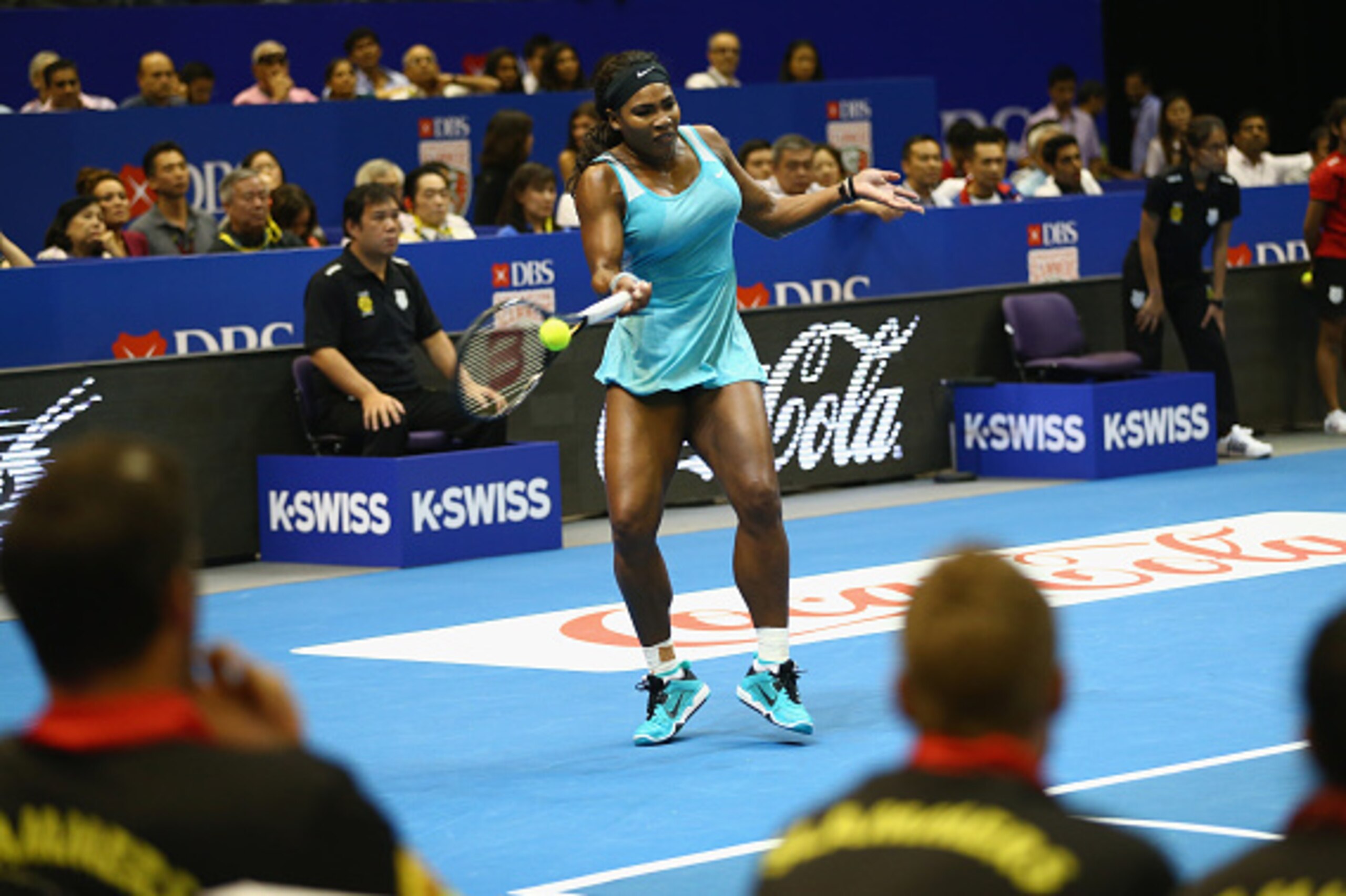 SINGAPORE - DECEMBER 04:  Serena Williams of the Singapore Slammers watched by her team mates as she plays against Caroline Wozniacki of the UAE Royals during the Coca-Cola International Premier Tennis League at the Singapore Sports Hub on December 4, 201