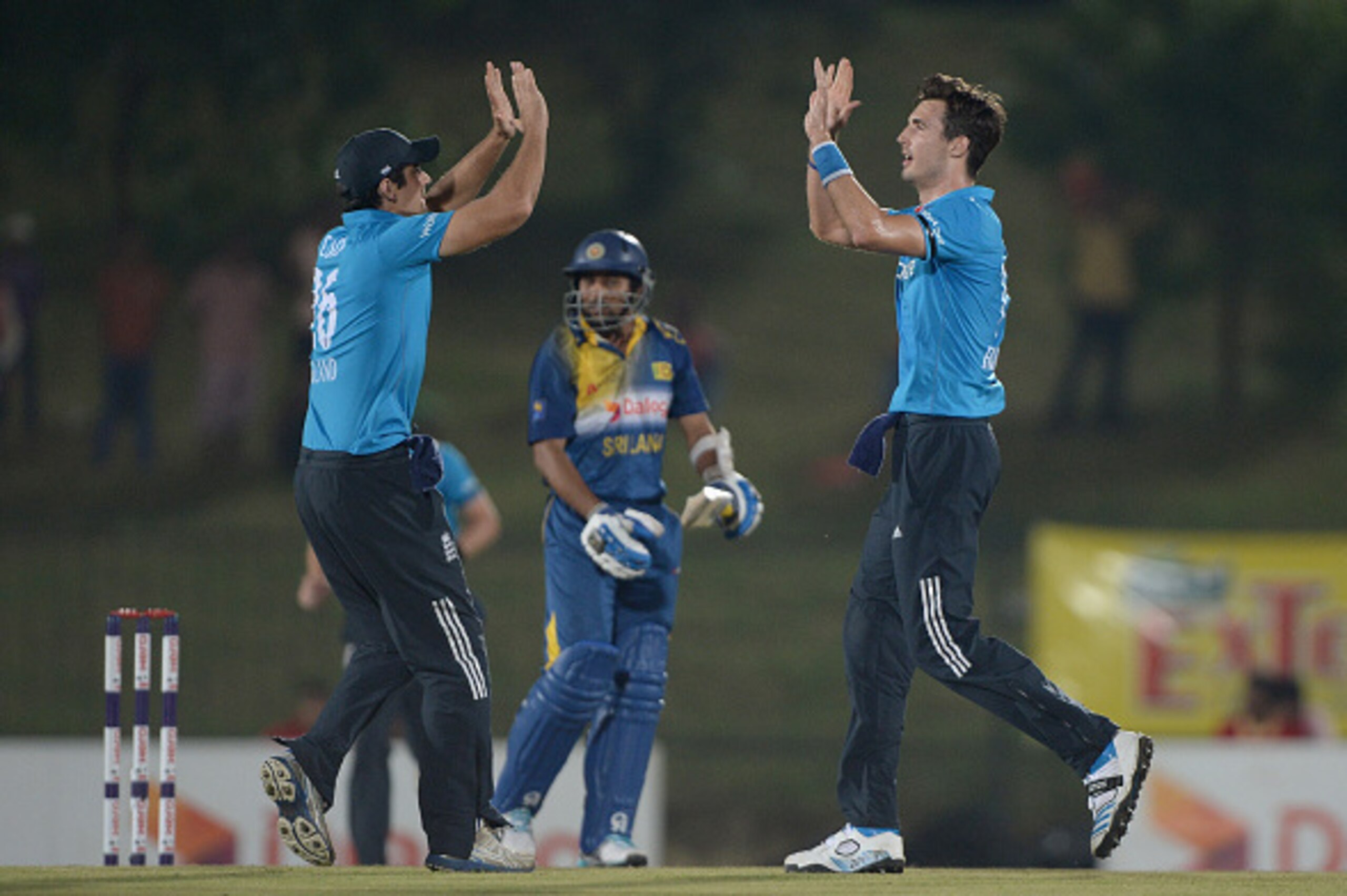 HAMBANTOTA, SRI LANKA - DECEMBER 03:  Steven Finn of England celebrates with England captain Alastair Cook after dismissing Tillakaratne Dilshan of Sri Lanka during the 3rd One Day International between Sri Lanka and England at Mahinda Rajapaksa Internati