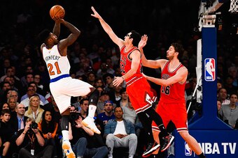 NEW YORK, NY - OCTOBER 29: Iman Shumpert #21 of the New York Knicks attempts a shot over Kirk Hinrich #12 and Pau Gasol #16 of the Chicago Bulls in the second quarter during a game at Madison Square Garden on October 29, 2014 in New York City. NOTE TO USE
