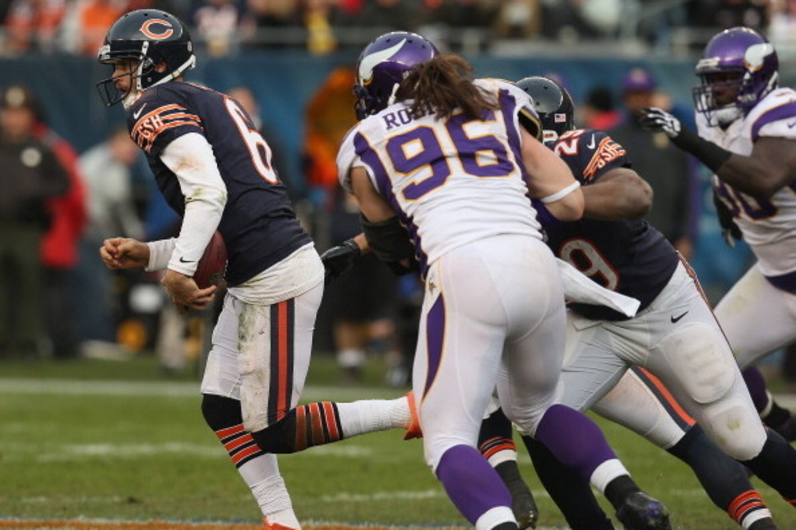 CHICAGO, IL - NOVEMBER 25:  Jay Cutler #6 of the Chicago Bears runs from Brian Robinson #96 of the Minnesota Vikings at Soldier Field on November 25, 2012 in Chicago, Illinois. The Bears defeated the Vikings 28-10.  (Photo by Jonathan Daniel/Getty Images)