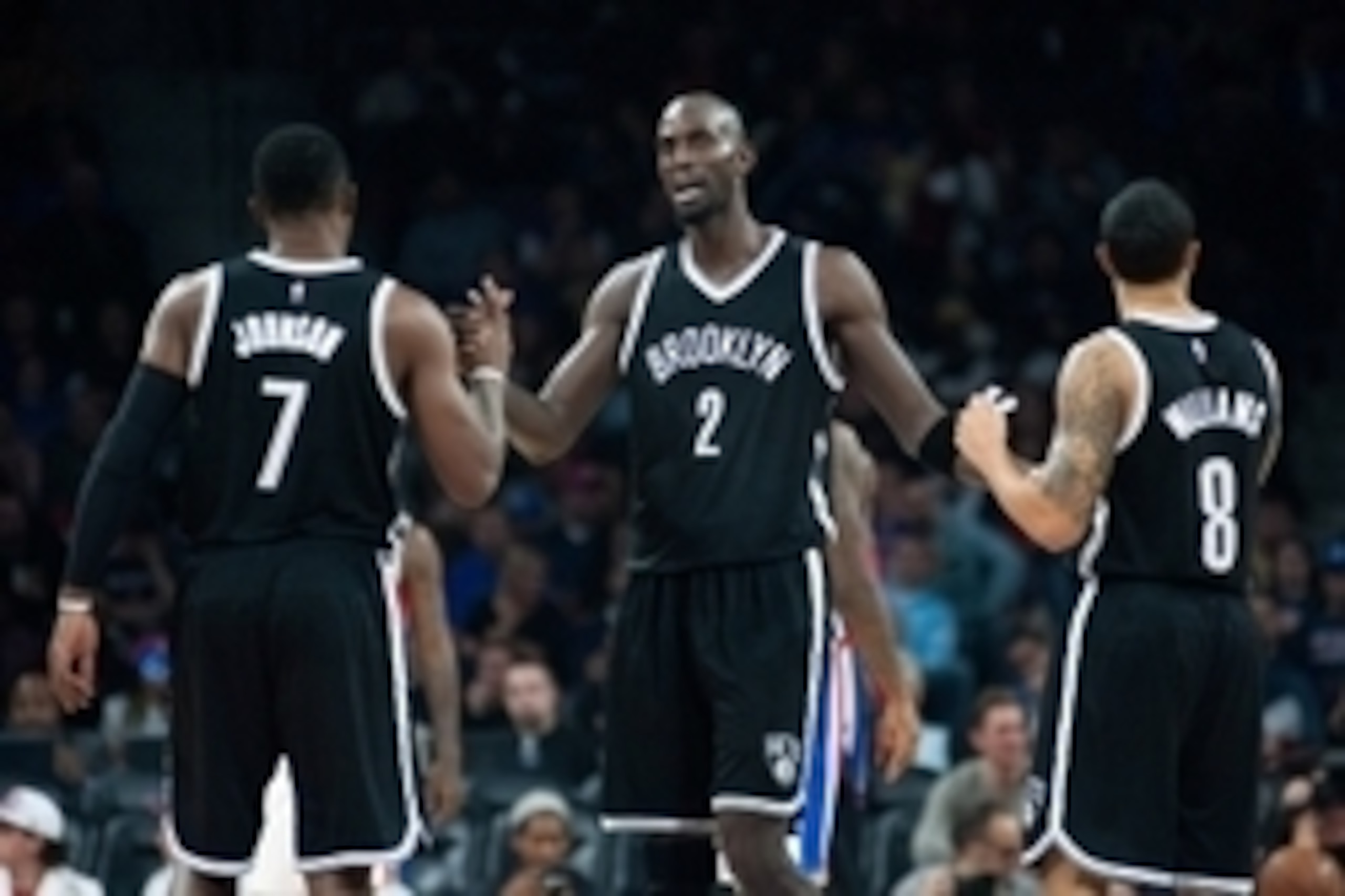 Nov 1, 2014; Auburn Hills, MI, USA; Brooklyn Nets center Kevin Garnett (2) high fives guard Joe Johnson (7) and guard Deron Williams (8) during the third quarter against the Detroit Pistons at The Palace of Auburn Hills. Mandatory Credit: Tim Fuller-USA T