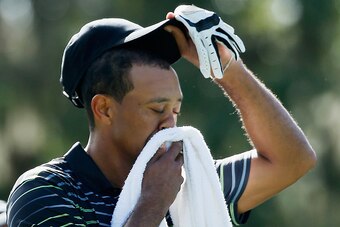WINDERMERE, FL - DECEMBER 04:  Tiger Woods wipes his face on the third tee during the first round the Hero World Challenge at the Isleworth Golf & Country Club on December 4, 2014 in Windermere, Florida.  (Photo by Scott Halleran/Getty Images)