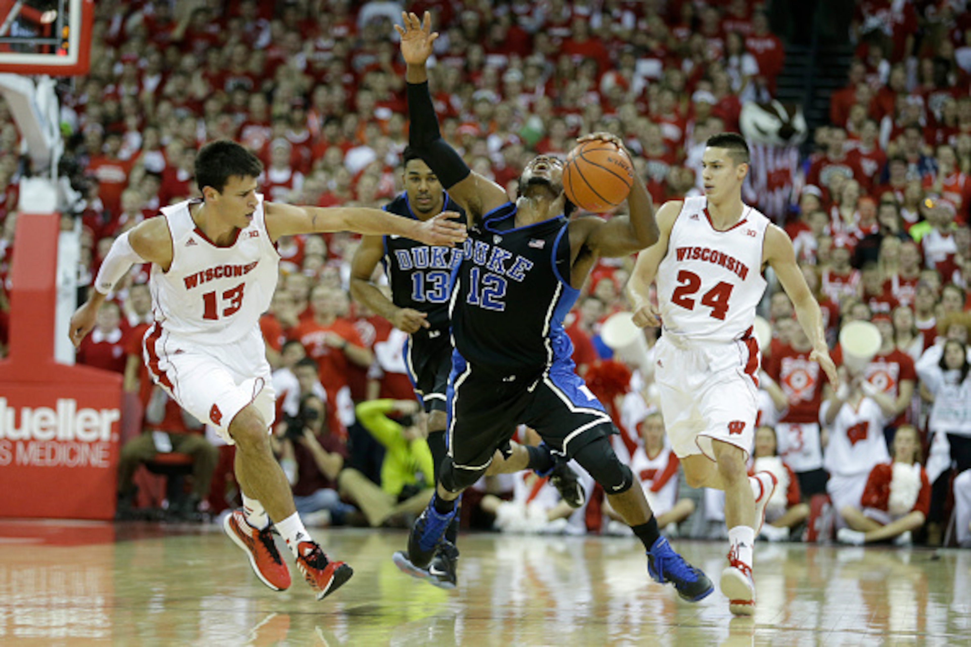MADISON, WI - DECEMBER 03: Justise Winslow #12 of the Duke Blue Devils gets fouled Duje Dukan #13 of the Wisconsin Badgers during the first half at Kohl Center on December 03, 2014 in Madison, Wisconsin. (Photo by Mike McGinnis/Getty Images) MADISON, WI - DECEMBER 03: Justise Winslow #12 of the Duke Blue Devils gets fouled Duje Dukan #13 of the Wisconsin Badgers during the first half at Kohl Center on December 03, 2014 in Madison, Wisconsin. (Photo by Mike McGinnis/Getty Images)