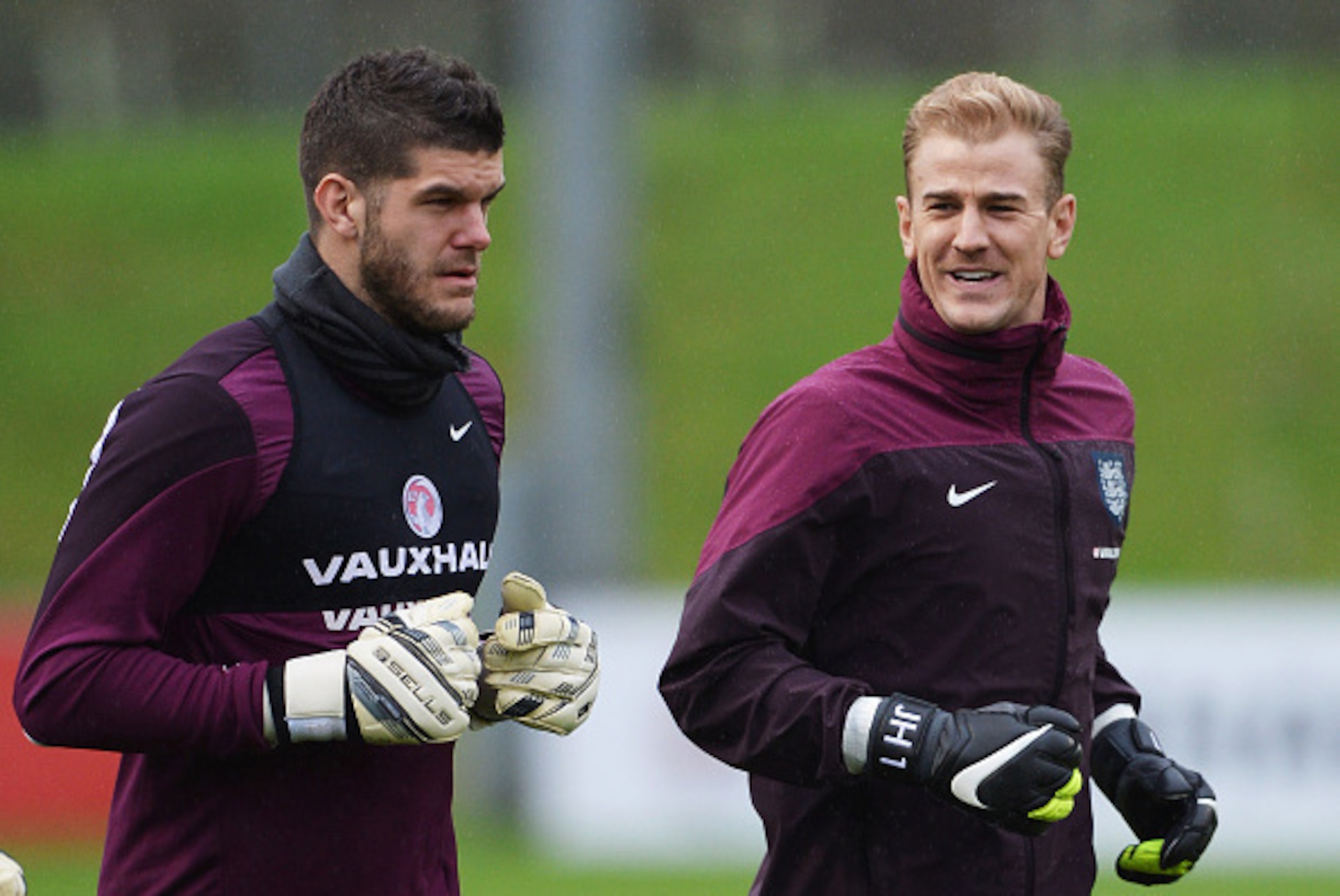 BURTON-UPON-TRENT, ENGLAND - NOVEMBER 14:  Goalkeepers Fraser Forster (L) and Joe Hart warm up during an England training session, ahead of the UEFA European Championship qualifier match against Slovenia, at St Georges Park on November 14, 2014 in Burton-