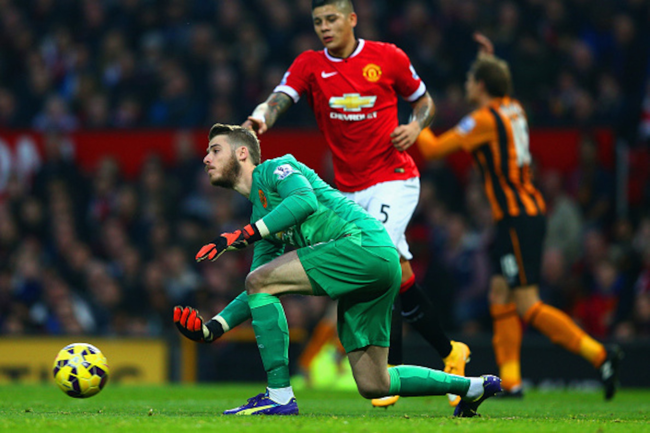 MANCHESTER, ENGLAND - NOVEMBER 29: David De Gea of Manchester United disptaches the ball during the Barclays Premier League match between Manchester United and Hull City at Old Trafford on November 29, 2014 in Manchester, England.  (Photo by Clive Mason/G