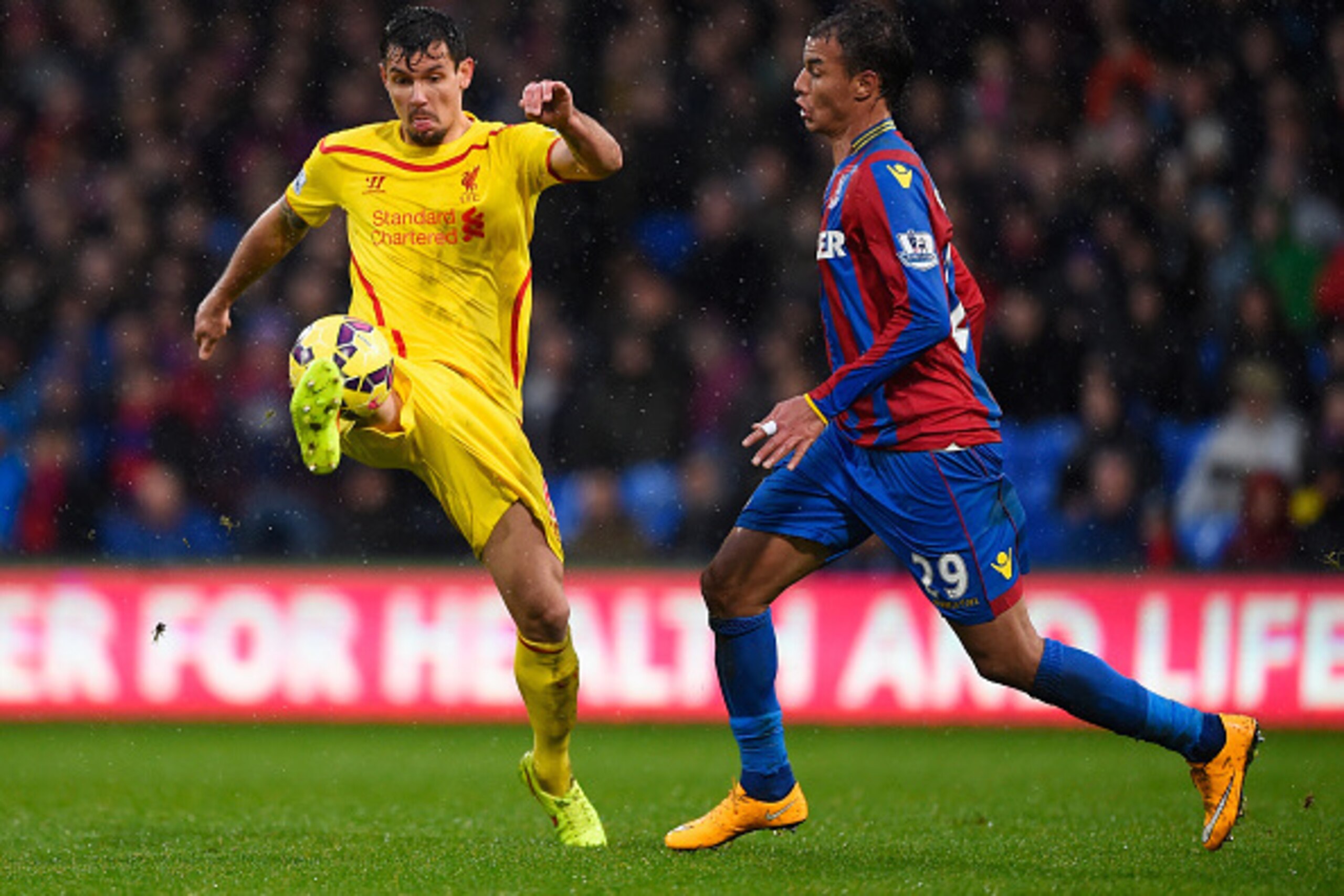 LONDON, ENGLAND - NOVEMBER 23: Dejan Lovren of Liverpool is closed down by Marouane Chamakh of Crystal Palace during the Barclays Premier League match between Crystal Palace and Liverpool at Selhurst Park on November 23, 2014 in London, England.  (Photo b