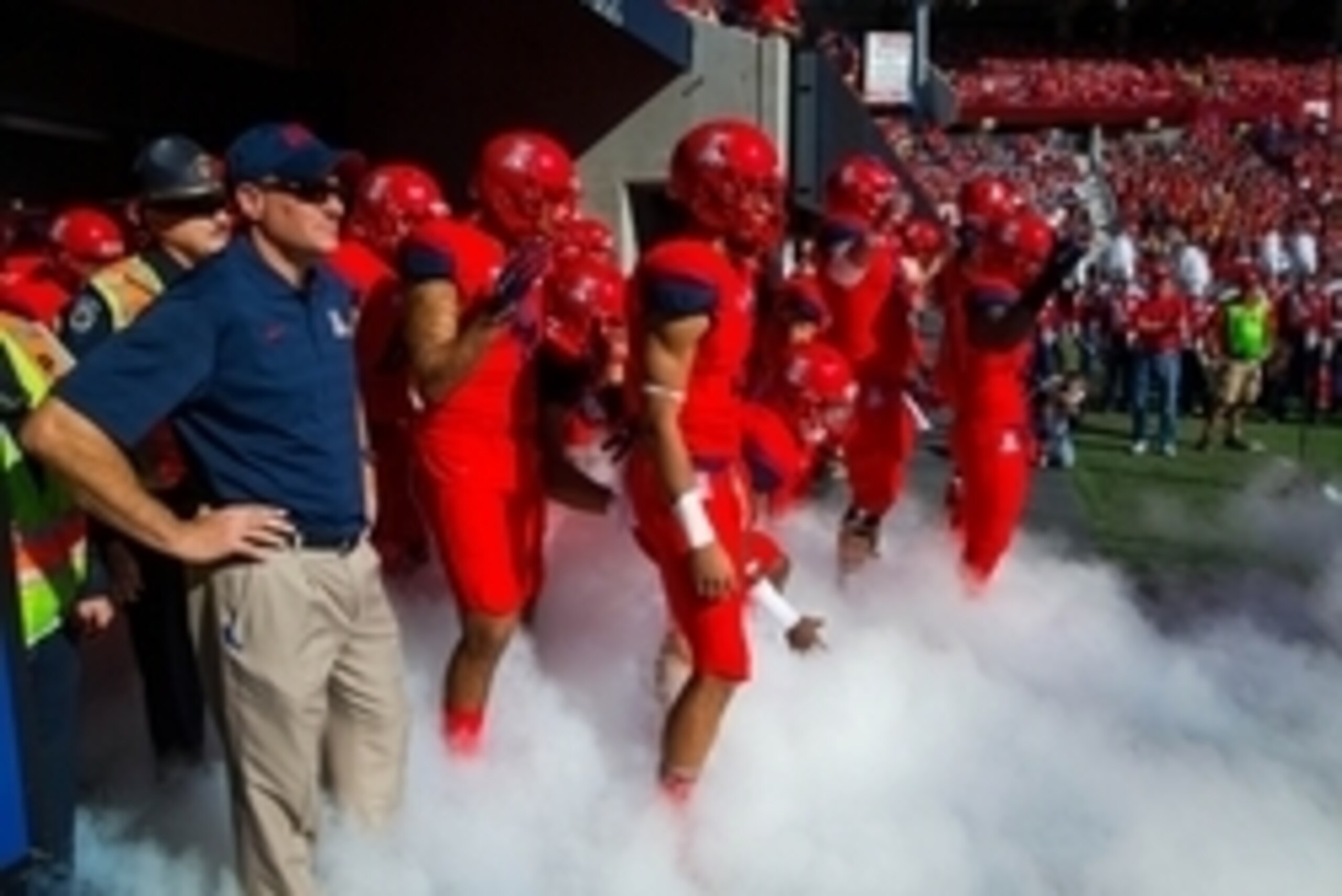 Nov 28, 2014; Tucson, AZ, USA; Arizona Wildcats head coach Rich Rodriguez (left) with his players prior to the game against the Arizona State Sun Devils during the 88th annual territorial cup at Arizona Stadium. The Wildcats defeated the Sun Devils 42-35 