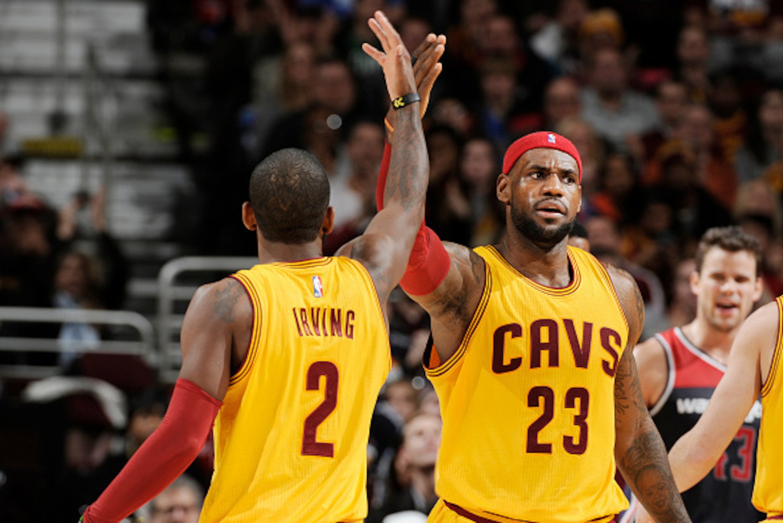 CLEVELAND, OH -  NOVEMBER 26: LeBron James #23 high fives teammate Kyrie Irving #2 of the Cleveland Cavaliers during the game against the Washington Wizards on November 26, 2014 at Quicken Loans Arena in Cleveland, Ohio. NOTE TO USER: User expressly ackno