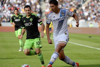 LOS ANGELES, CA - NOVEMBER 23:  Omar Gonzalez #4 of Los Angeles Galaxy looks to pass as he is chased by Marco Pappa #10 of Seattle Sounders FC during the Western Conference Final at StubHub Center on November 23, 2014 in Los Angeles, California.  (Photo b