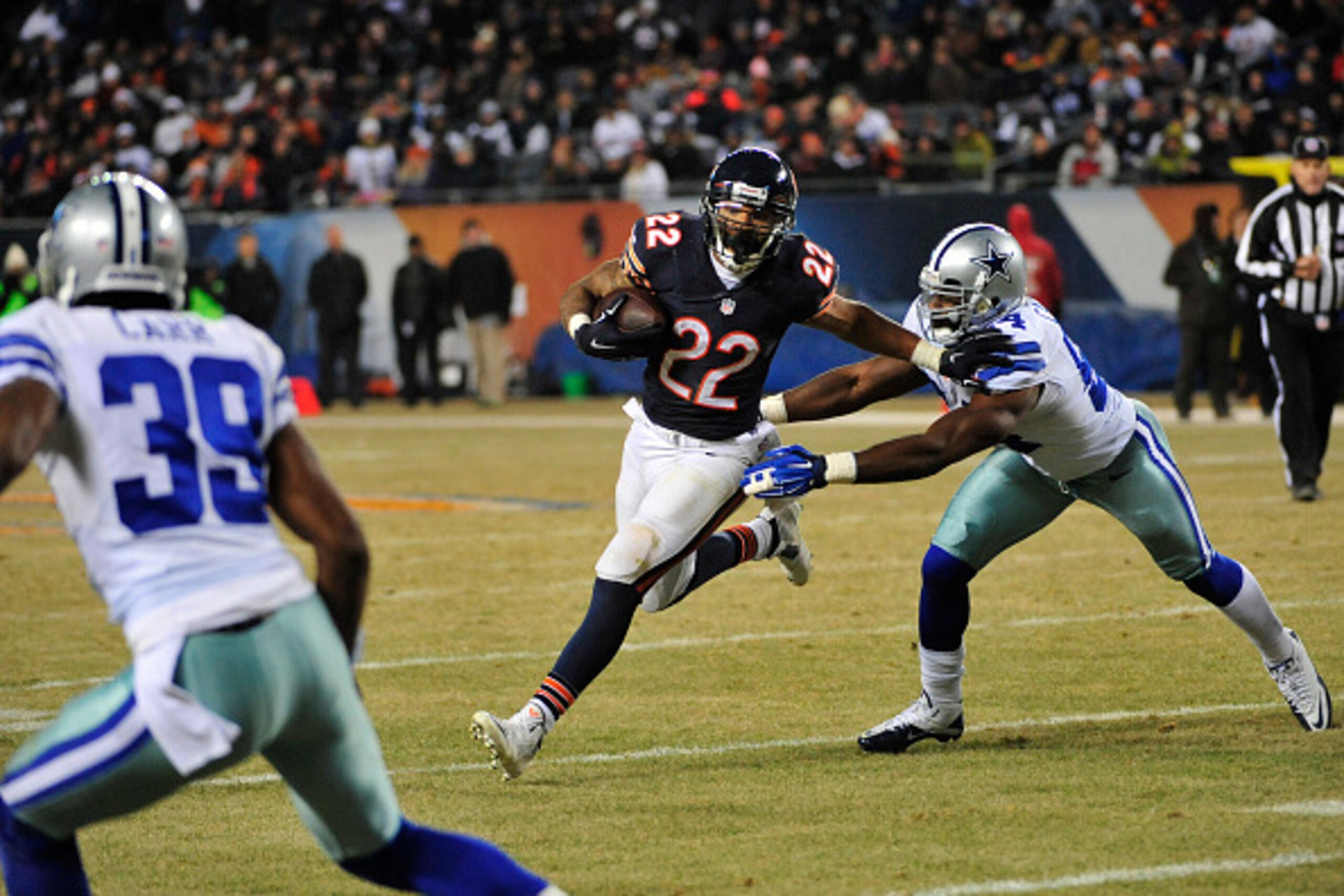 CHICAGO, IL - DECEMBER 04: Matt Forte #22 of the Chicago Bears is defended by Bruce Carter #54 of the Dallas Cowboys during the fourth quarter on December 4, 2014 at Soldier Field in Chicago, Illinois.  The Dallas Cowboys defeated the Chicago Bears 41-28.
