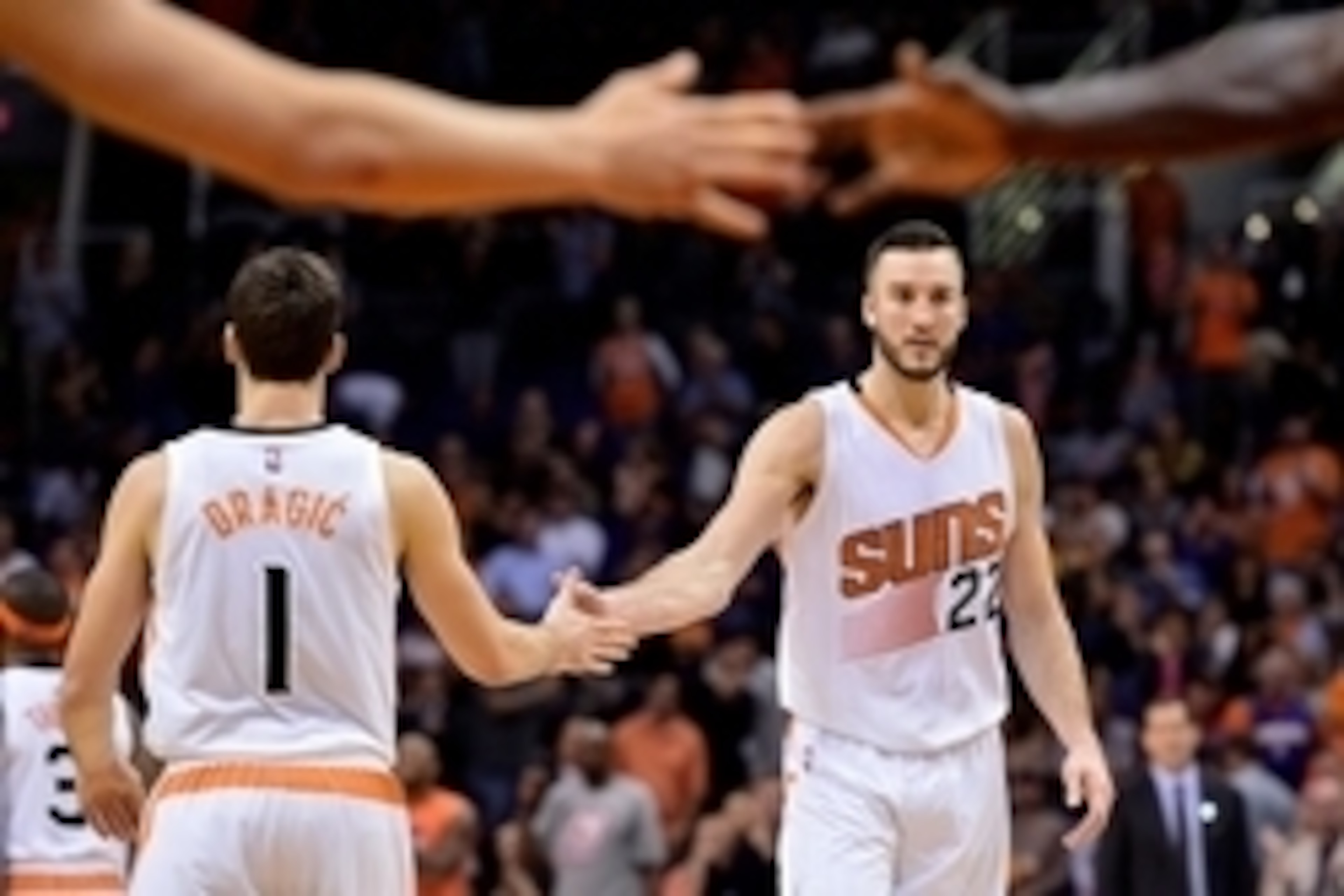 Nov 12, 2014; Phoenix, AZ, USA; Phoenix Suns center Miles Plumlee (22) is high fives by teammate guard Goran Dragic (1) in the second half against the Brooklyn Nets at US Airways Center. The Suns won 112-104. Mandatory Credit: Jennifer Stewart-USA TODAY S