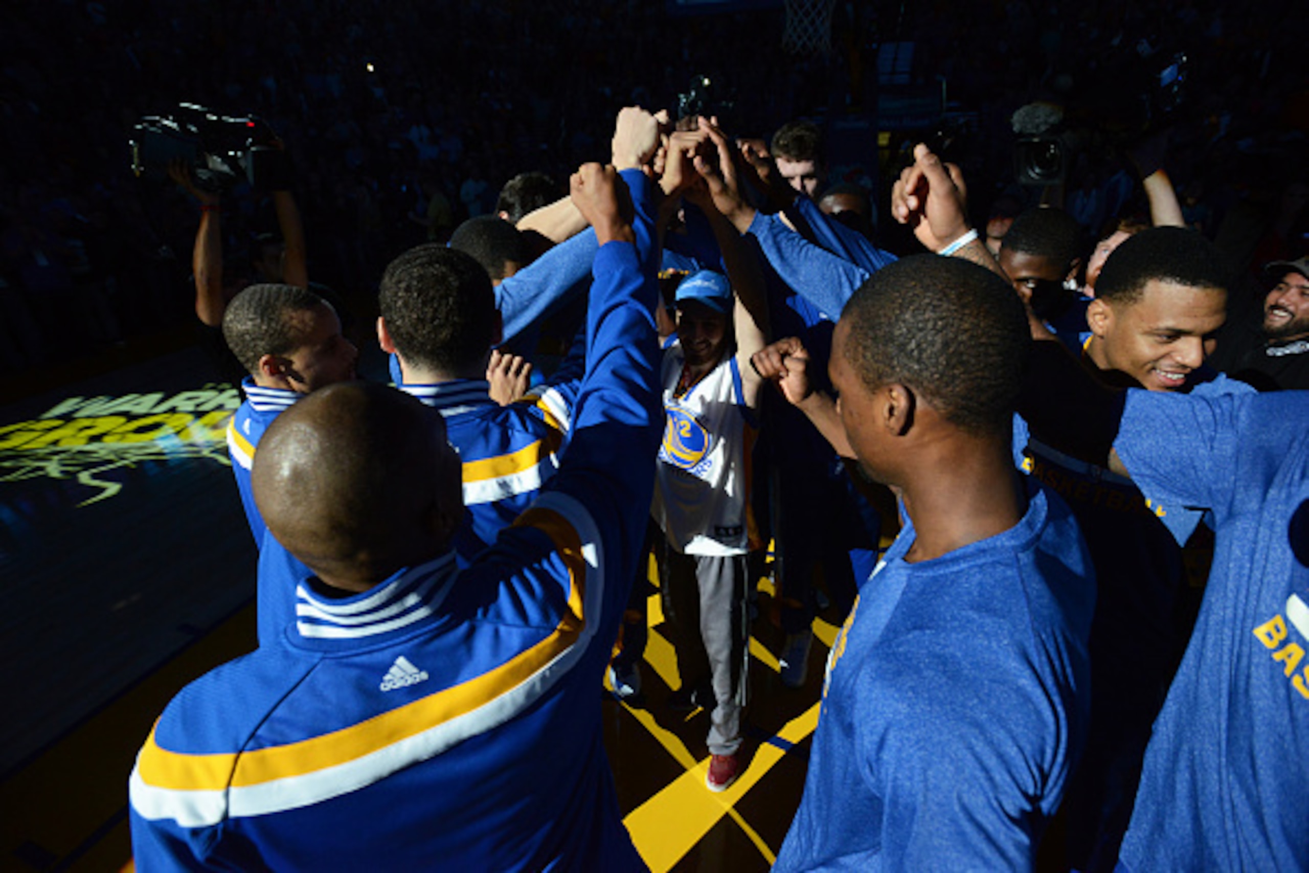 OAKLAND, CA - DECEMBER 4: The Golden State Warriors huddle with Make-A-Wish Recipient Trent Frost prior to the game against the New Orleans Pelicans on December 4, 2014 at Oracle Arena in Oakland, California. NOTE TO USER: User expressly acknowledges and 