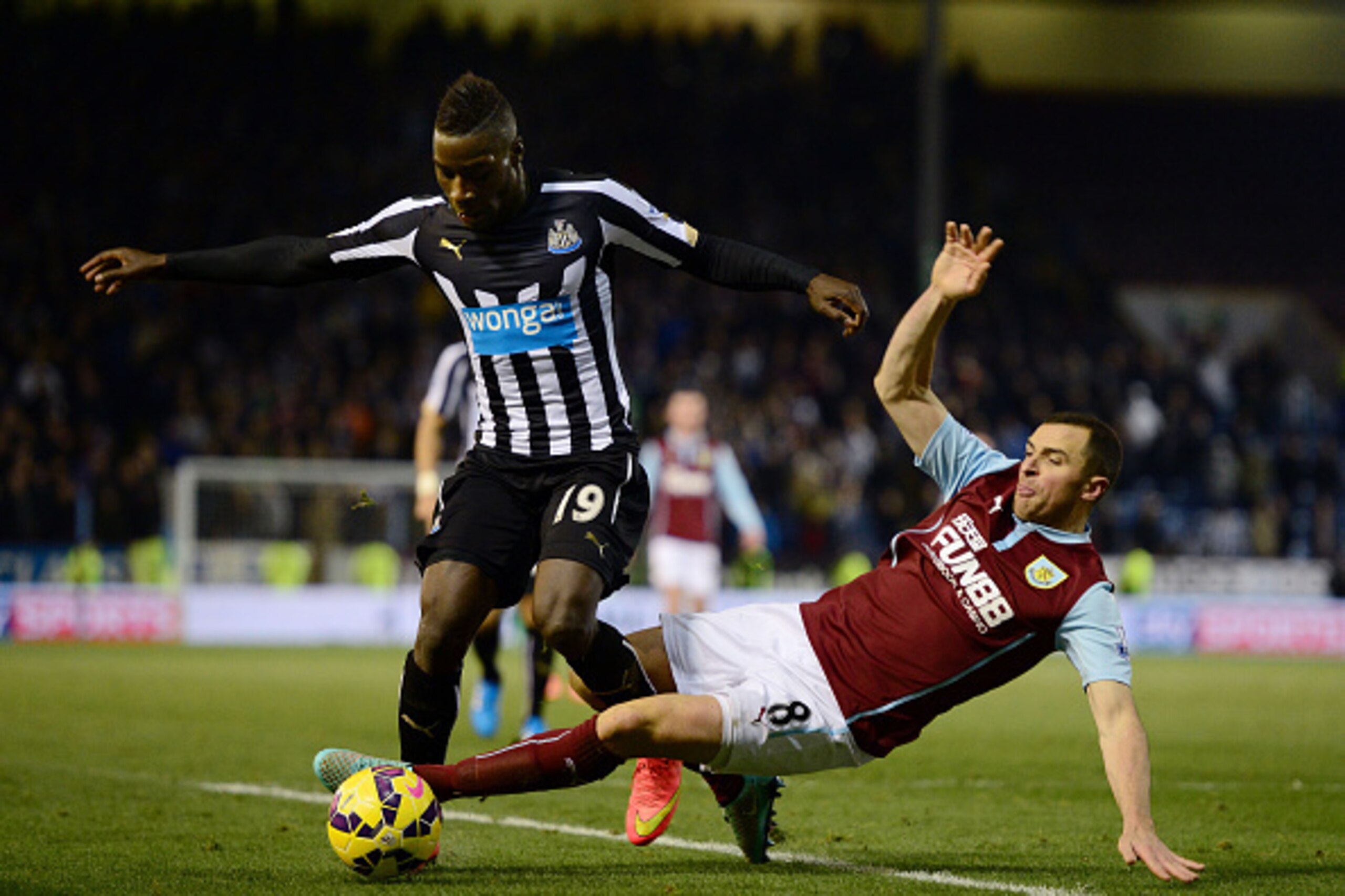 BURNLEY, ENGLAND - DECEMBER 02:  Massadio Haidara of Newcastle United is tackled by Dean Marney of Burnley during the Barclays Premier League match between Burnley and Newcastle United at Turf Moor on December 2, 2014 in Burnley, England.  (Photo by Jamie