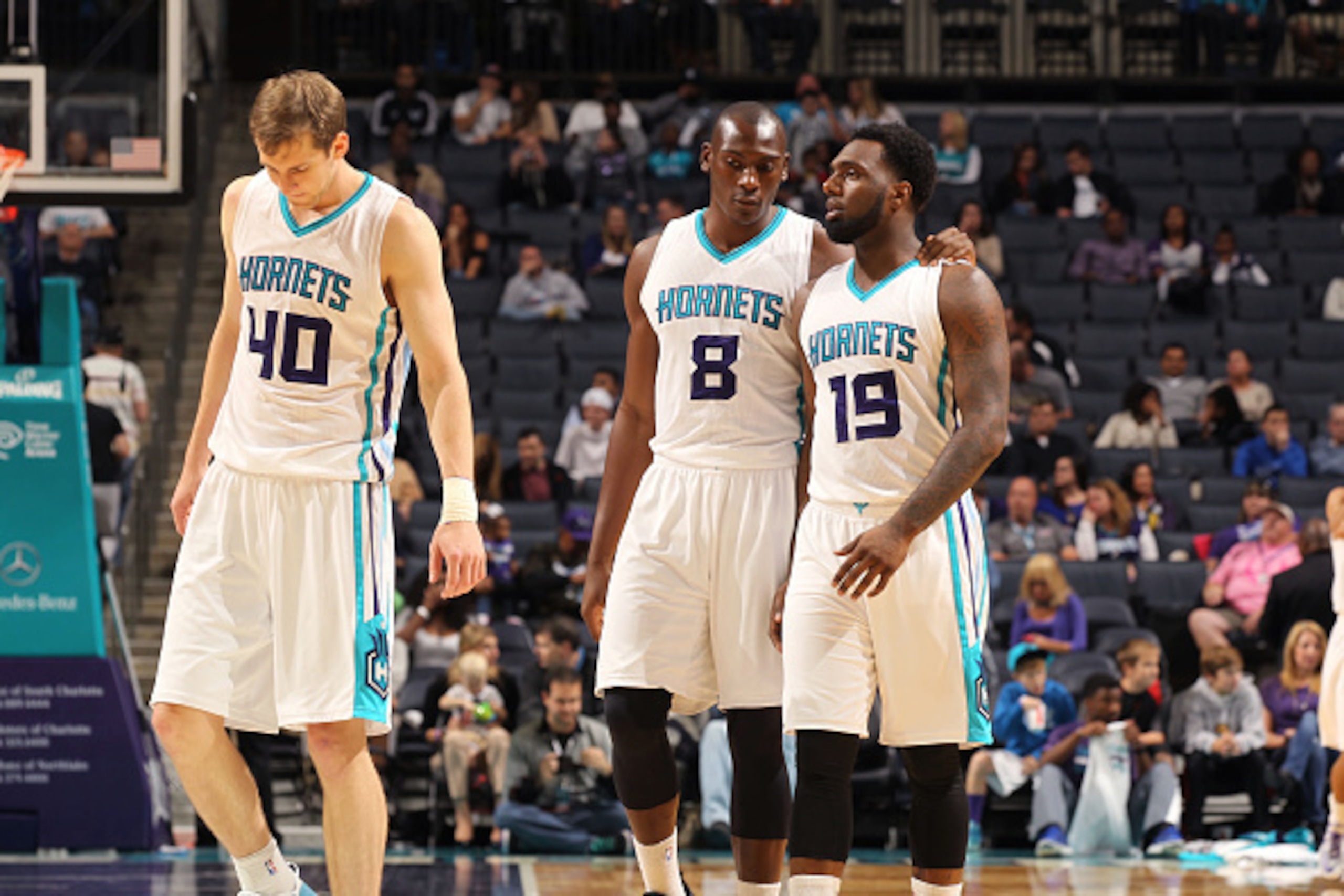 CHARLOTTE, NC - OCTOBER 23: Cody Zeller #40, Bismack Biyombo #8 and P.J. Hairston #19 of the Charlotte Hornets talk as they walk off court during the game against the Indiana Pacers at the Time Warner Cable Arena on October 23, 2014 in Charlotte, North Ca