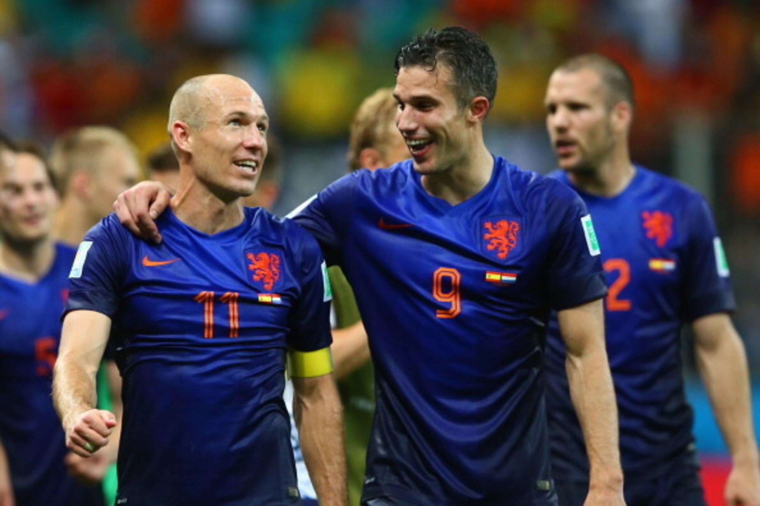 SALVADOR, BRAZIL - JUNE 13:  Arjen Robben (L) and Robin van Persie of the Netherlands walk off the field after scoring two goals each and defeating Spain 5-1 during the 2014 FIFA World Cup Brazil Group B match between Spain and Netherlands at Arena Fonte 