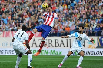 MADRID, SPAIN - NOVEMBER 30:  Mario Mandzukic of Club Atletico de Madrid heads the ball during the La Liga match between Club Atletico de Madrid and RC Deportivo La Coruna   at Vicente Calderon Stadium on November 30, 2014 in Madrid, Spain.  (Photo by Den