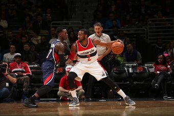 WASHINGTON, DC - NOVEMBER 25:  John Wall #2 of the Washington Wizards handles the ball against Dennis Schroder #17 of the Atlanta Hawkson November 25, 2014 at the Verizon Center in Washington, DC. NOTE TO USER: User expressly acknowledges and agrees that,