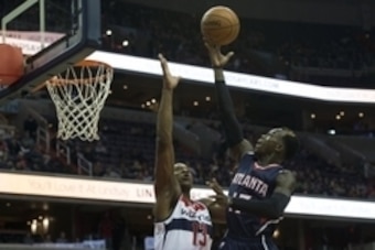 Nov 25, 2014; Washington, DC, USA; Atlanta Hawks guard Dennis Schroder (17) shoots over Washington Wizards center Kevin Seraphin (13) during the second quarter at Verizon Center. Mandatory Credit: Tommy Gilligan-USA TODAY Sports