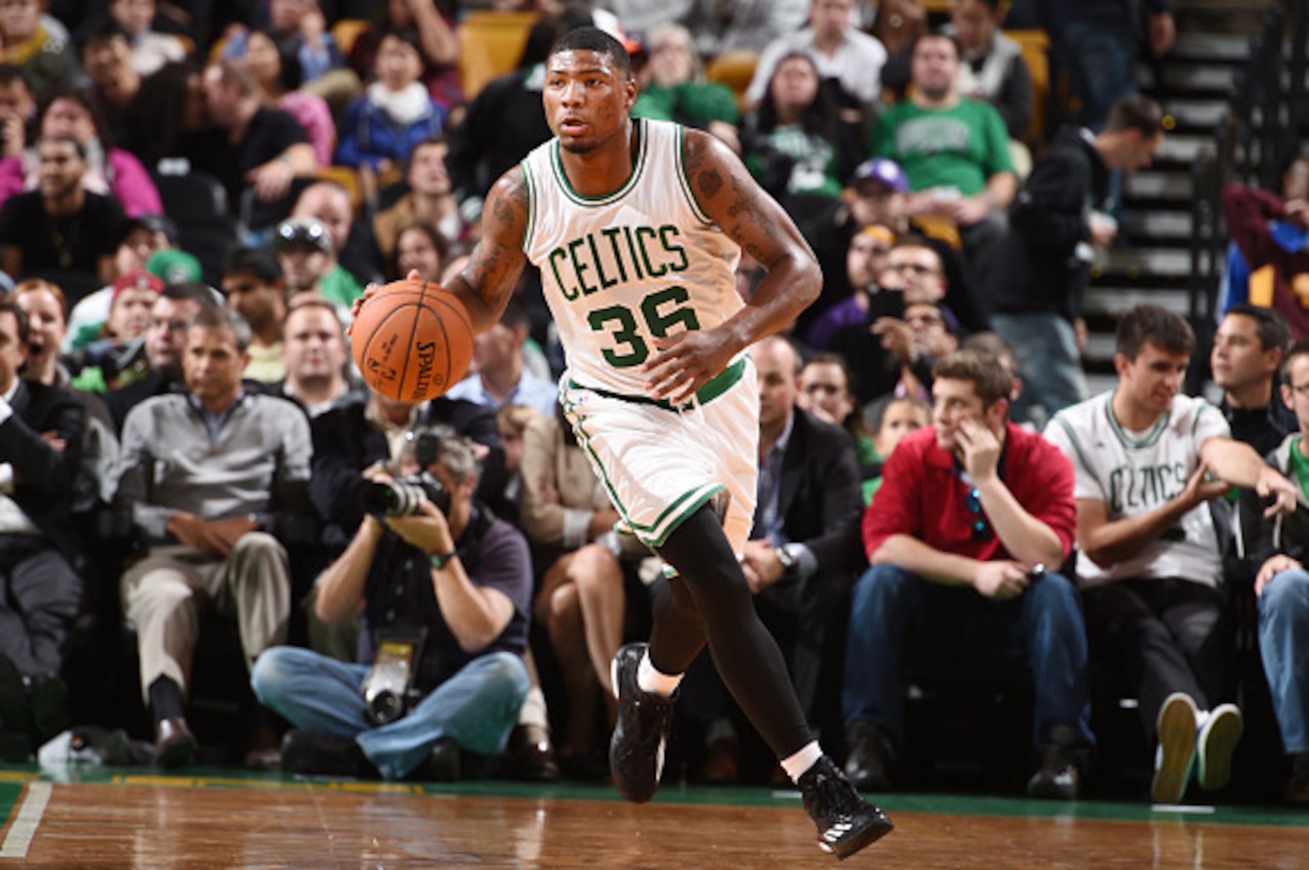 BOSTON, MA - OCTOBER 6: Marcus Smart #36 of the Boston Celtics dribbles the ball against the Philadelphia 76ers on October 6, 2014 at the TD Garden in Boston, Massachusetts.  NOTE TO USER: User expressly acknowledges and agrees that, by downloading and or