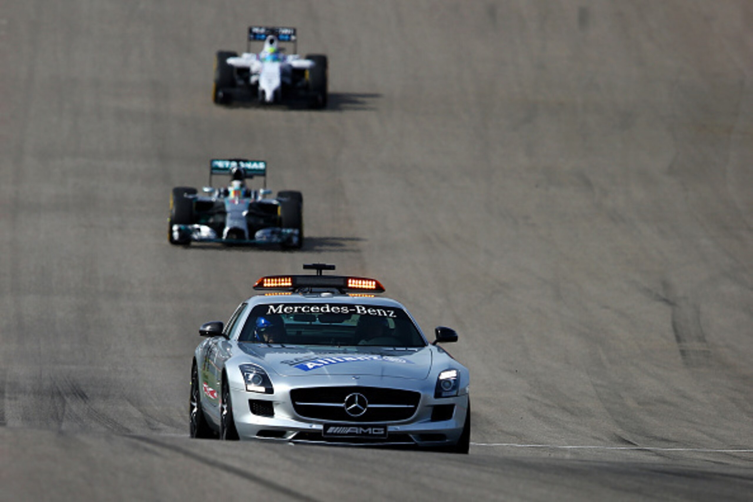 AUSTIN, TX - NOVEMBER 02:  The safety car drives in front of Lewis Hamilton of Great Britain and Mercedes GP during the United States Formula One Grand Prix at Circuit of The Americas on November 2, 2014 in Austin, United States.  (Photo by Mark Thompson/