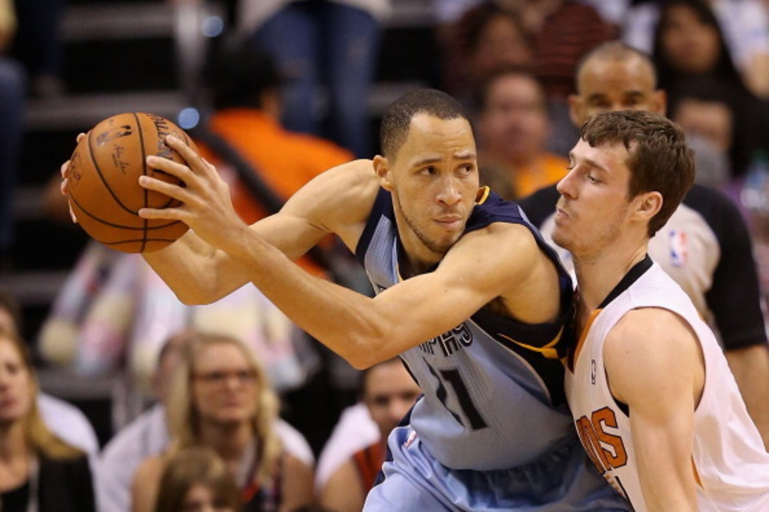 PHOENIX, AZ - APRIL 14:  Tayshaun Prince #21 of the Memphis Grizzlies looks to move the bal under pressure from Goran Dragic #1 of the Phoenix Suns during the second half of the NBA game at US Airways Center on April 14, 2014 in Phoenix, Arizona. The Griz