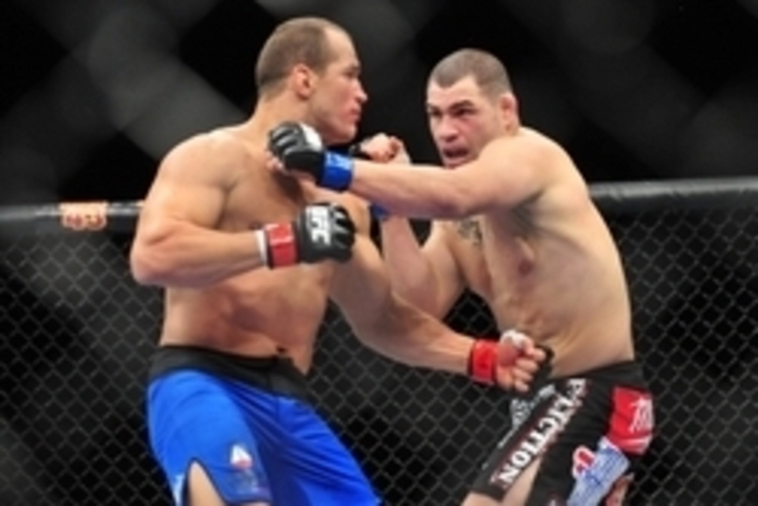 Dec 29, 2012; Las Vegas, NV, USA; Junior Dos Santos (left) and Cain Velasquez (right) exchange strikes during UFC 155 at the MGM Grand Garden Arena. Mandatory Credit: Gary A. Vasquez-USA TODAY Sports