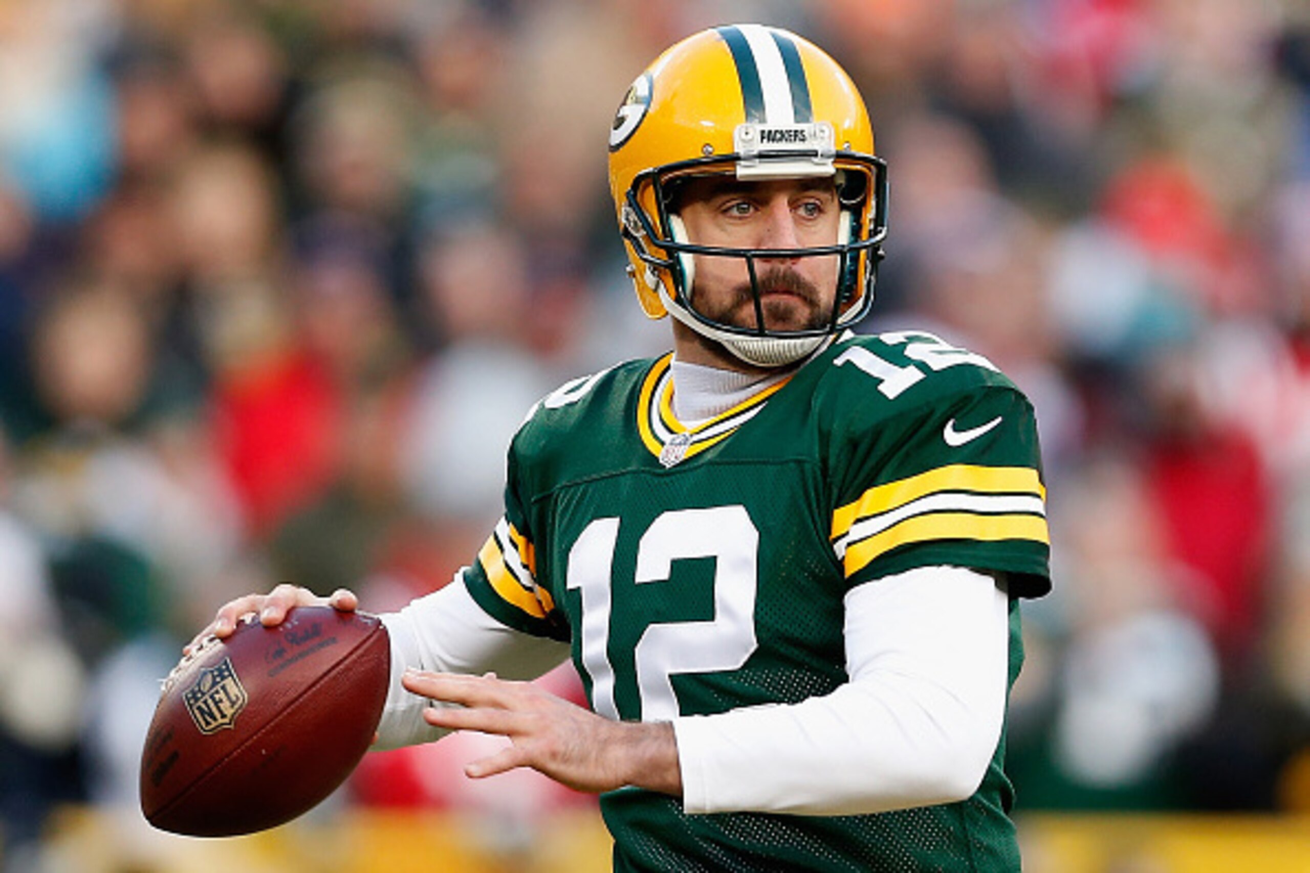 GREEN BAY, WI - NOVEMBER 30:  Quarterback Aaron Rodgers #12 of the Green Bay Packers dops back to pass during the NFL game against the New England Patriots at Lambeau Field on November 30, 2014 in Green Bay, Wisconsin. The Packers defeated the Patriots 26