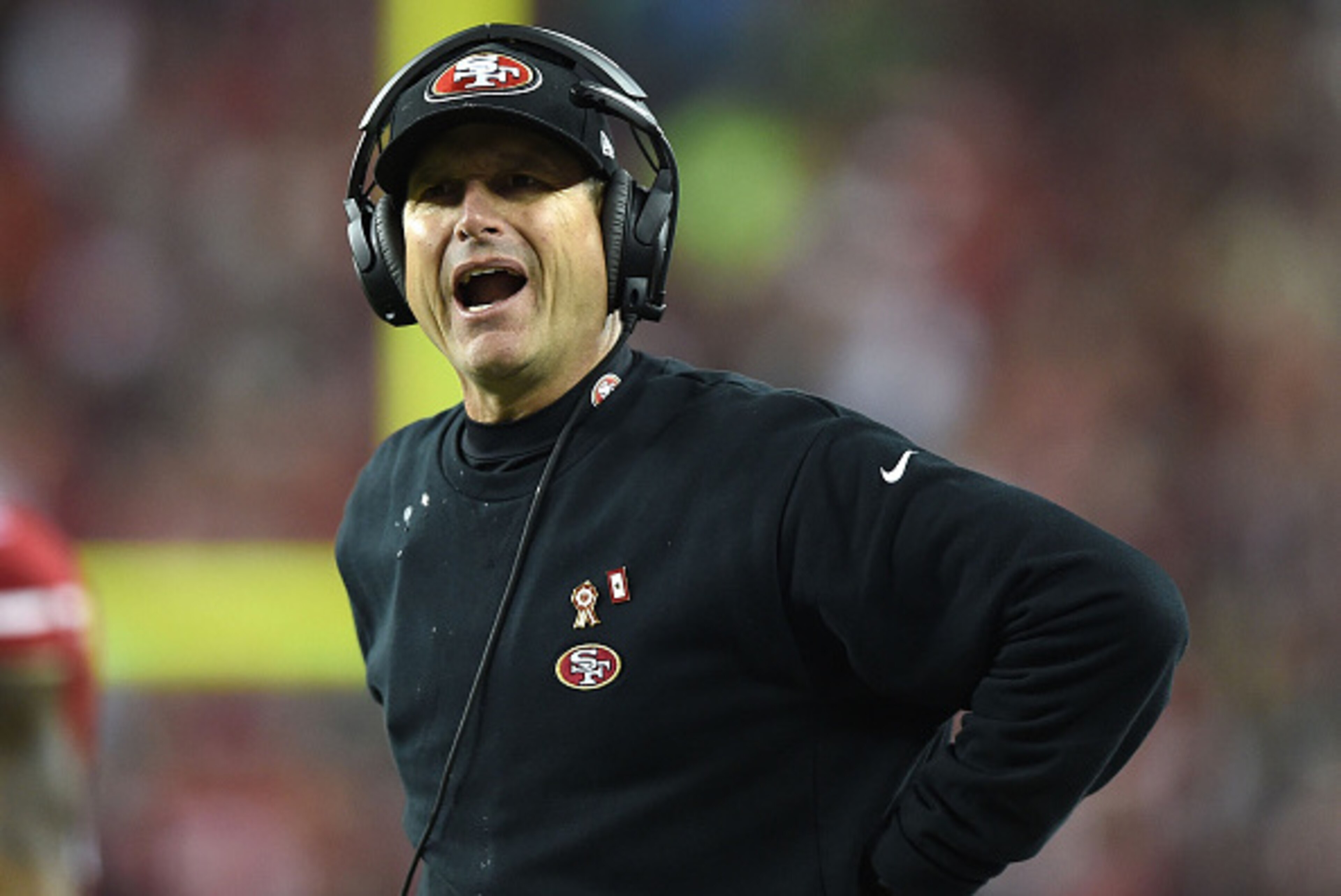 SANTA CLARA, CA - NOVEMBER 27:  Head coach Jim Harbaugh of the San Francisco 49ers argues a call against the Seattle Seahawks in the first half at Levi's Stadium on November 27, 2014 in Santa Clara, California.  (Photo by Thearon W. Henderson/Getty Images