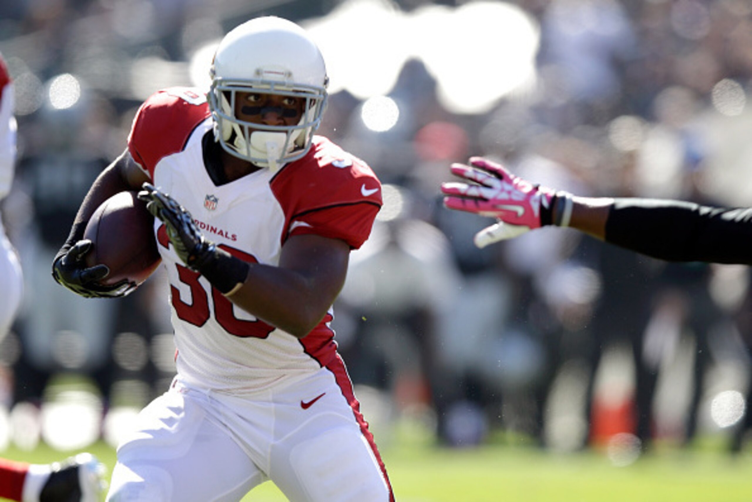 OAKLAND, CA - OCTOBER 19: Stepfan Taylor #30 of the Arizona Cardinals avoids the defender in the first half against the Oakland Raiders at O.co Coliseum on October 19, 2014 in Oakland, California. (Photo by Ezra Shaw/Getty Images)