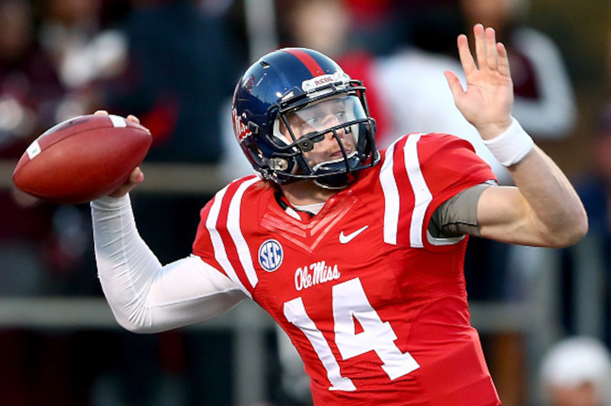 OXFORD, MS - NOVEMBER 29:  Bo Wallace #14 of the Mississippi Rebels drops back to pass against the Mississippi State Bulldogs during their game at Vaught-Hemingway Stadium on November 29, 2014 in Oxford, Mississippi.  (Photo by Streeter Lecka/Getty Images