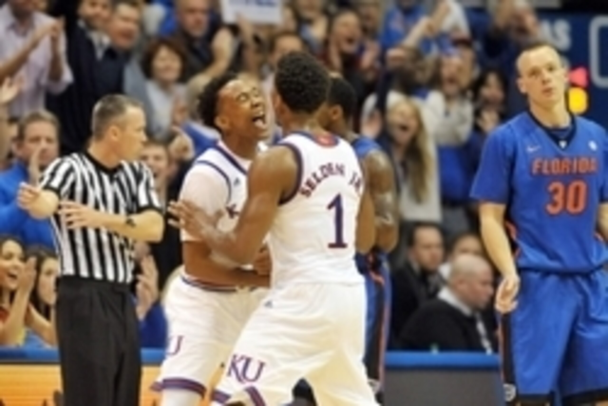Dec 5, 2014; Lawrence, KS, USA; Kansas Jayhawks guard Devonte Graham (4) and guard Wayne Selden Jr. (1) celebrate a call during the second half against the Florida Gators at Allen Fieldhouse. Kansas won 71-65. Mandatory Credit: Denny Medley-USA TODAY Spor