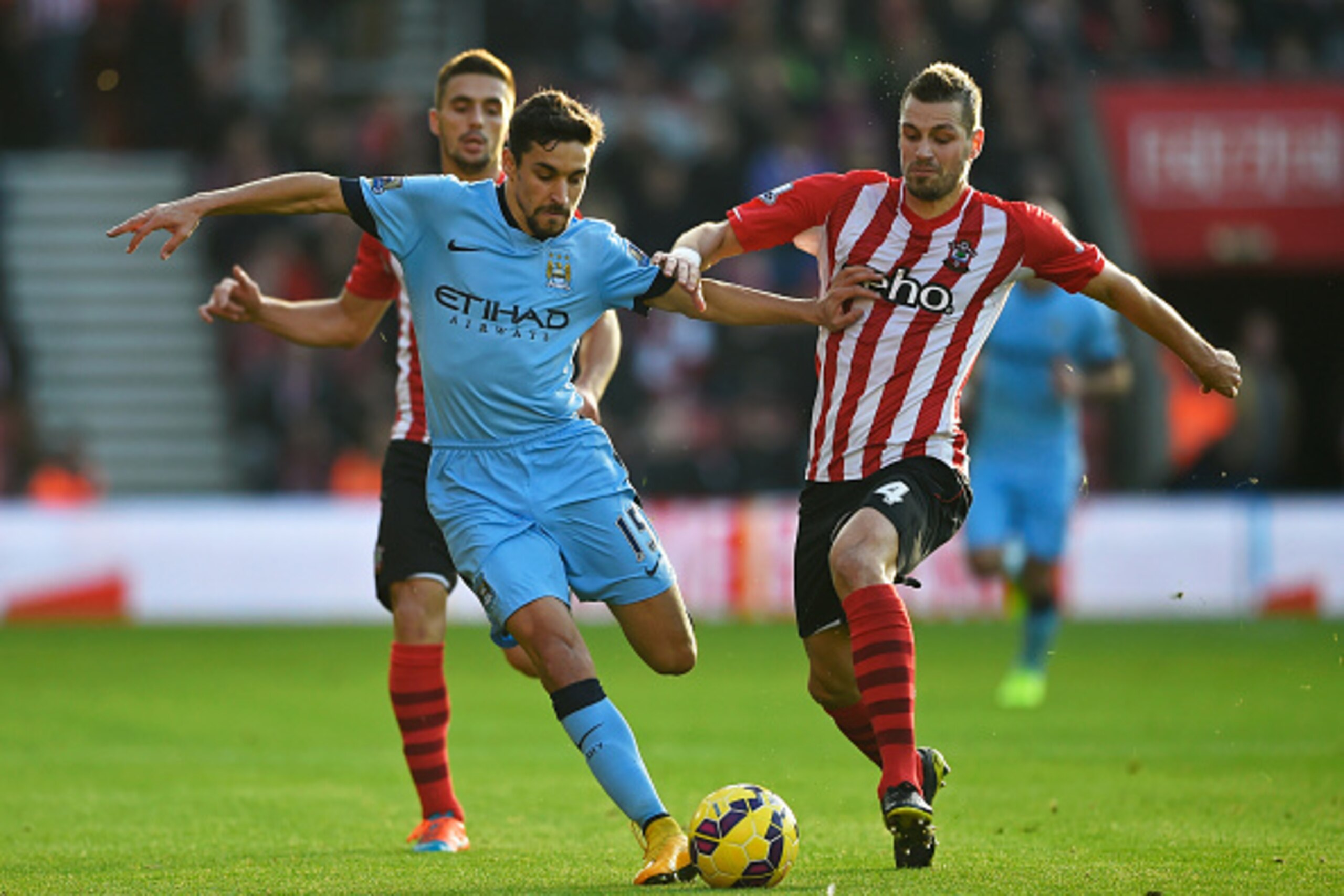 SOUTHAMPTON, ENGLAND - NOVEMBER 30: Jesus Navas of Manchester City holds off Morgan Schneiderlin of Southampton during the Barclays Premier League match between Southampton and Manchester City at St Mary's Stadium on November 30, 2014 in Southampton, Eng SOUTHAMPTON, ENGLAND - NOVEMBER 30: Jesus Navas of Manchester City holds off Morgan Schneiderlin of Southampton during the Barclays Premier League match between Southampton and Manchester City at St Mary's Stadium on November 30, 2014 in Southampton, Eng