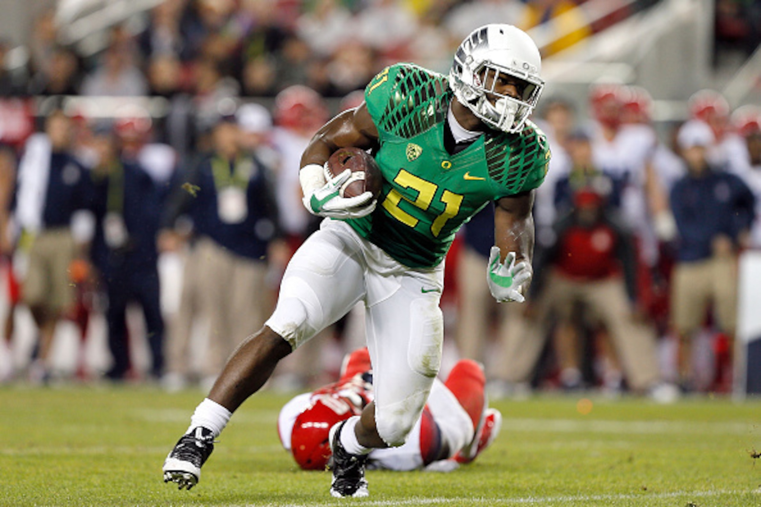 SANTA CLARA, CA - DECEMBER 05: Royce Freeman #21 of the Oregon Ducks keeps on his feet for a gain during the first half against the Arizona Wildcats in the PAC-12 Championships at Levi's Stadium on December 5, 2014 in Santa Clara, California. (Photo by Br