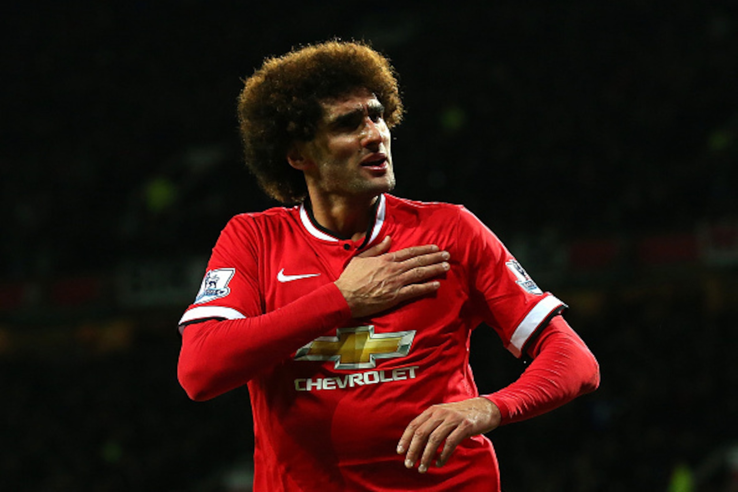 MANCHESTER, ENGLAND - DECEMBER 02:  Marouane Fellaini of Manchester United  celebrates scoring the first goal during the Barclays Premier League match between Manchester United and Stoke City at Old Trafford on December 2, 2014 in Manchester, England.  (P