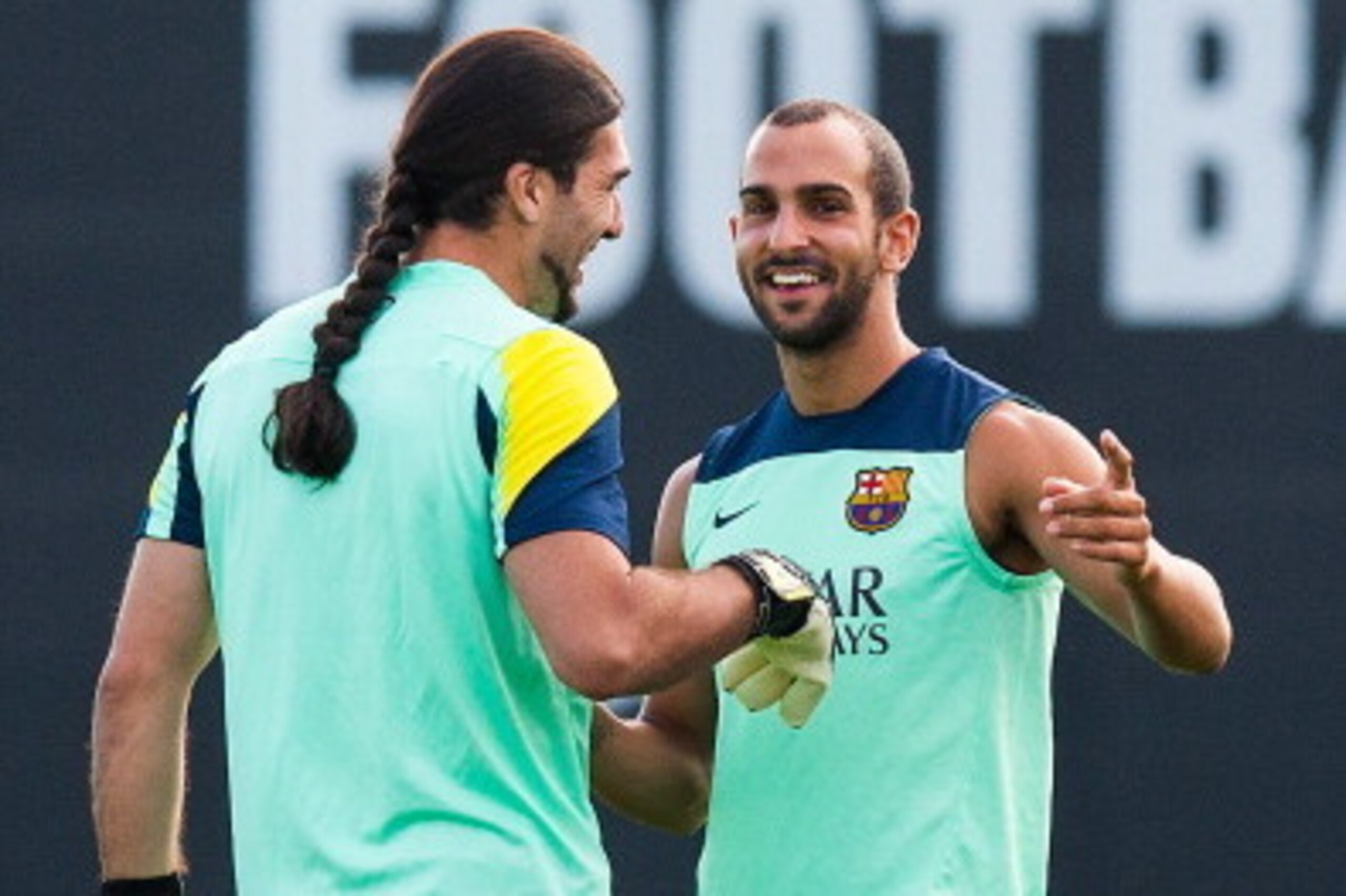 BARCELONA, SPAIN - JULY 18: Jose Manuel Pinto (R) and Martin Montoya of FC Barcelona joke during a training session at the Sant Joan Despi sport complex on July 18, 2013 in Barcelona, Spain.  (Photo by David Ramos/Getty Images)